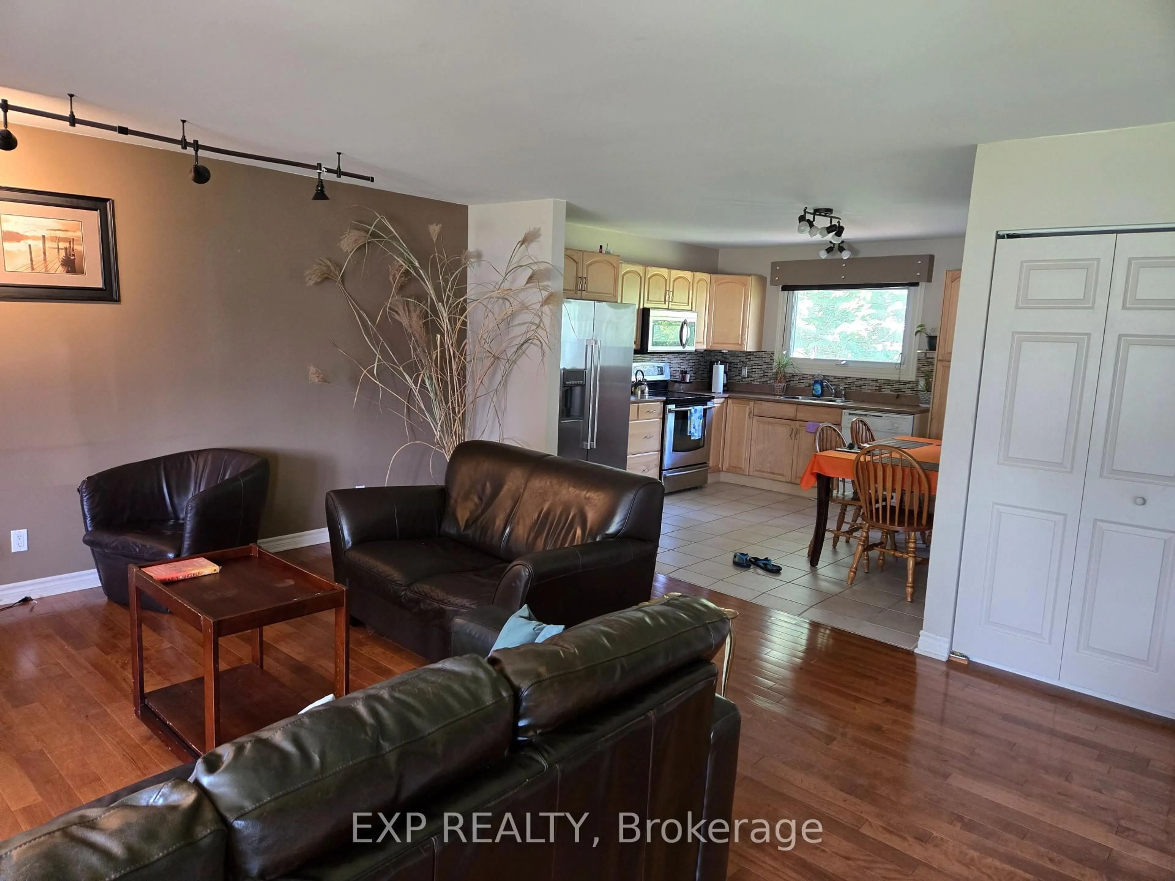 Living room with furniture, wood/laminate floor for 1990 Belcourt Blvd, Orleans Ontario K1C 1M5