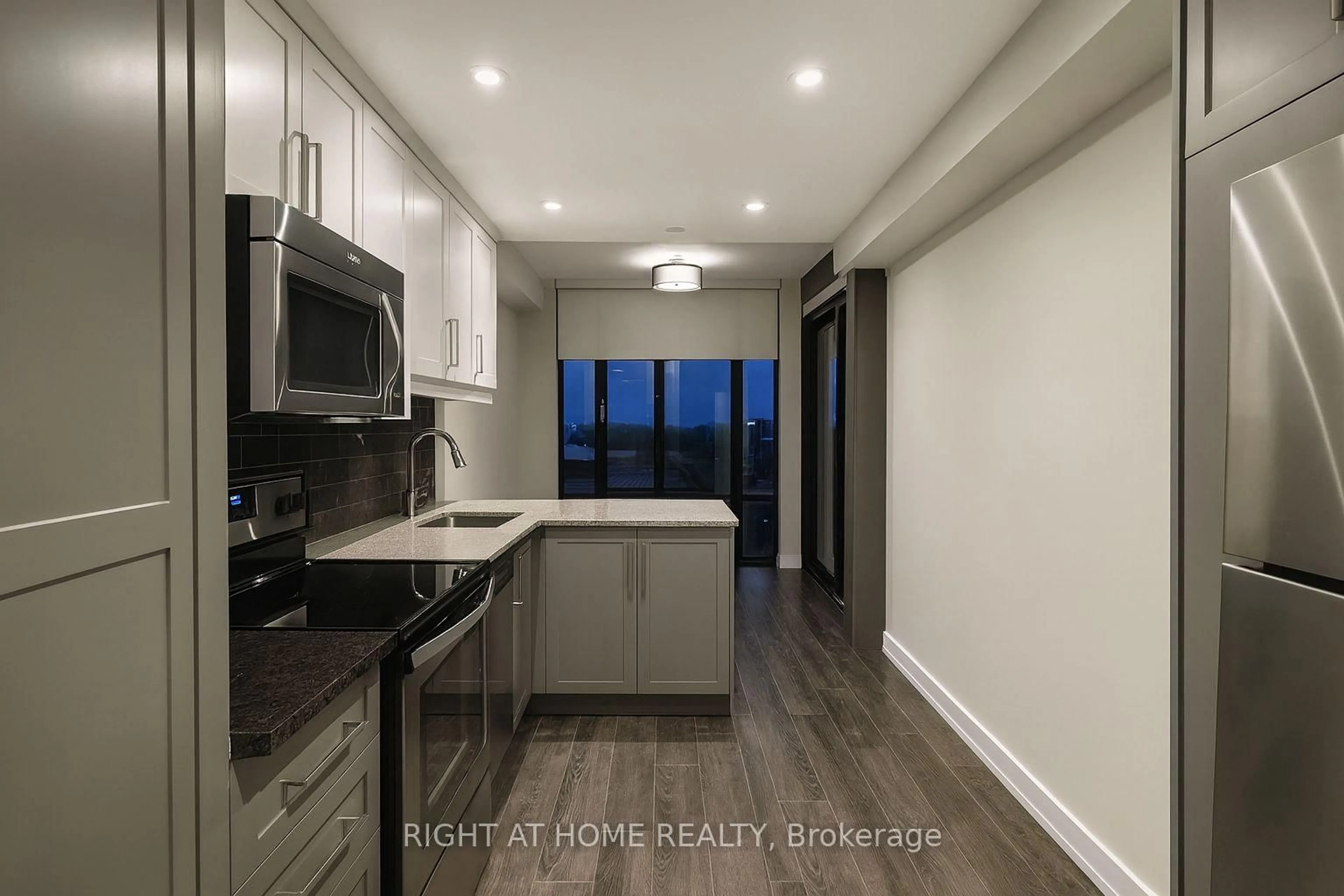 Open concept kitchen, wood/laminate floor for 330 Phillip St #N1803, Waterloo Ontario N2L 3W9