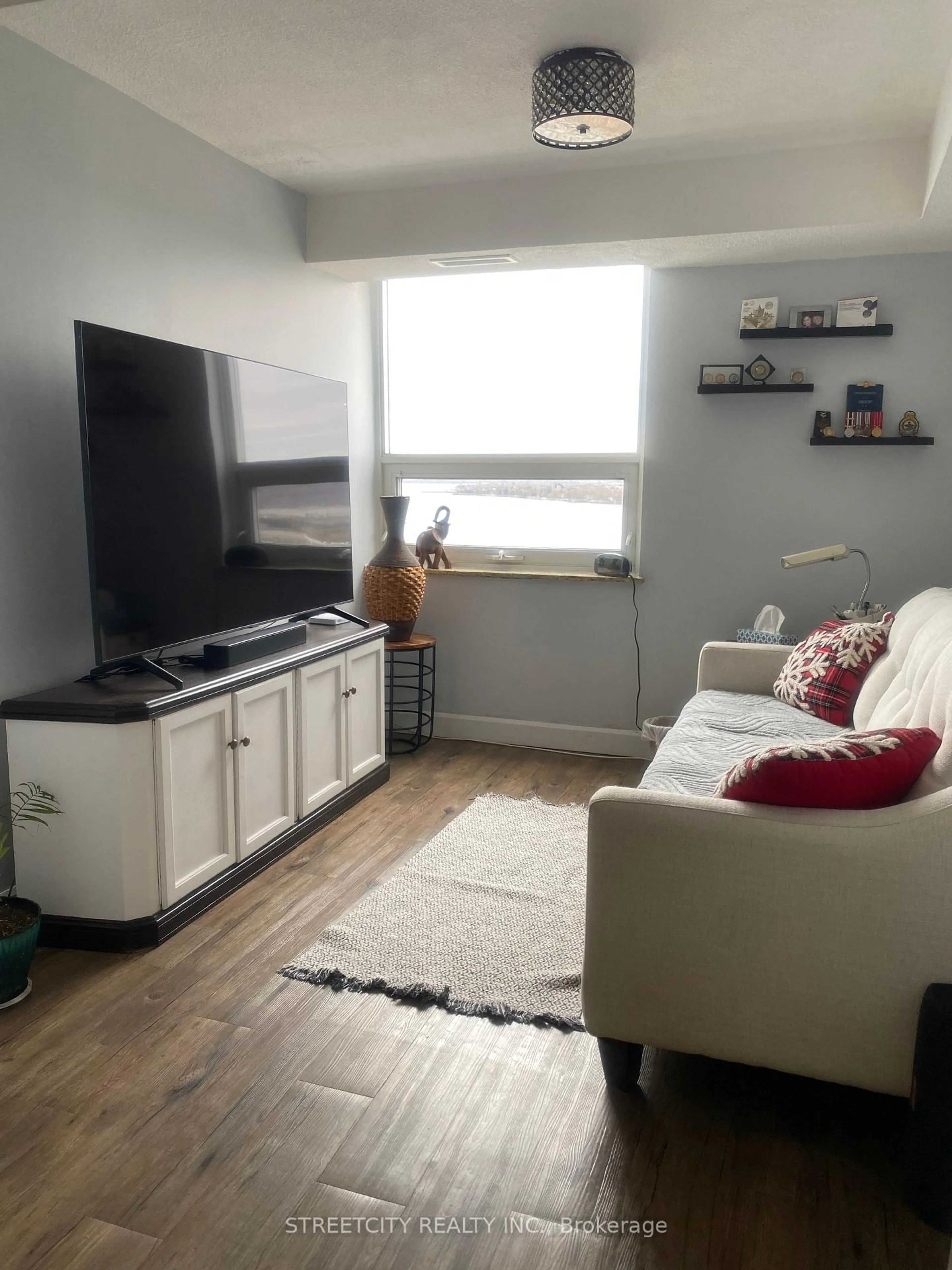 Living room with furniture, unknown for 500 Green Rd #1607, Hamilton Ontario L8E 3M6