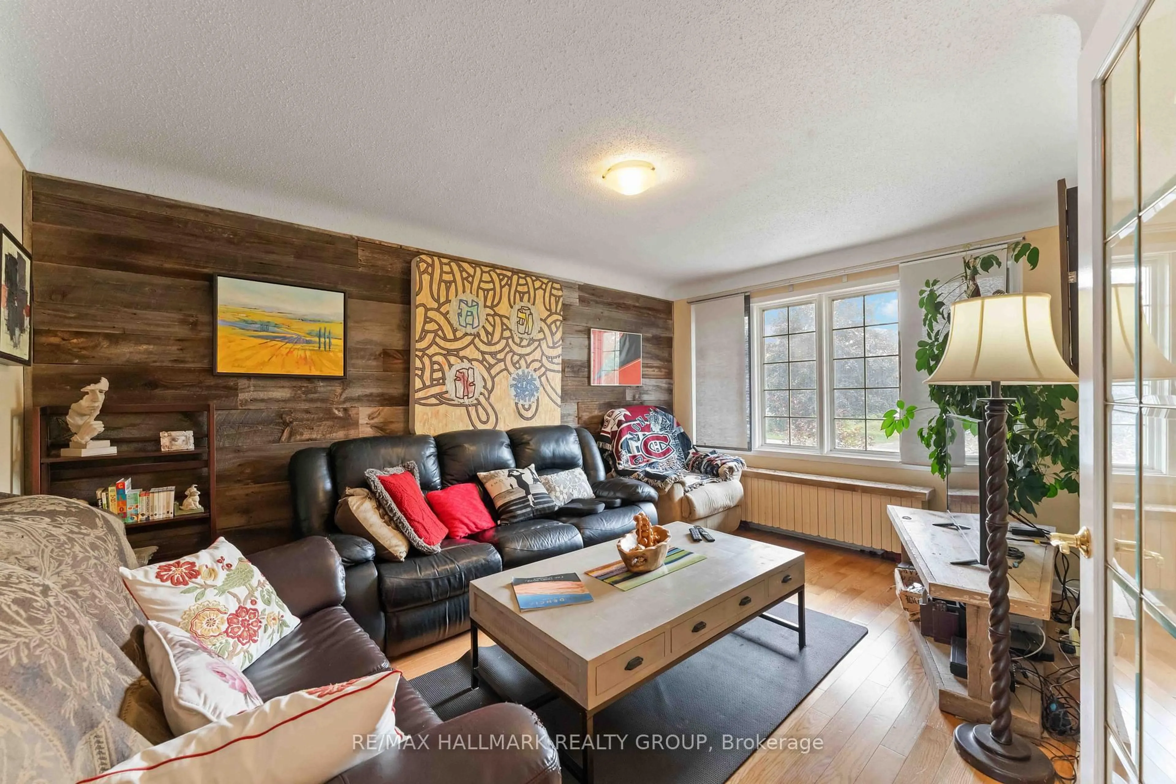 Living room with furniture, wood/laminate floor for 431 Blake Blvd, Ottawa Ontario K1K 1A9