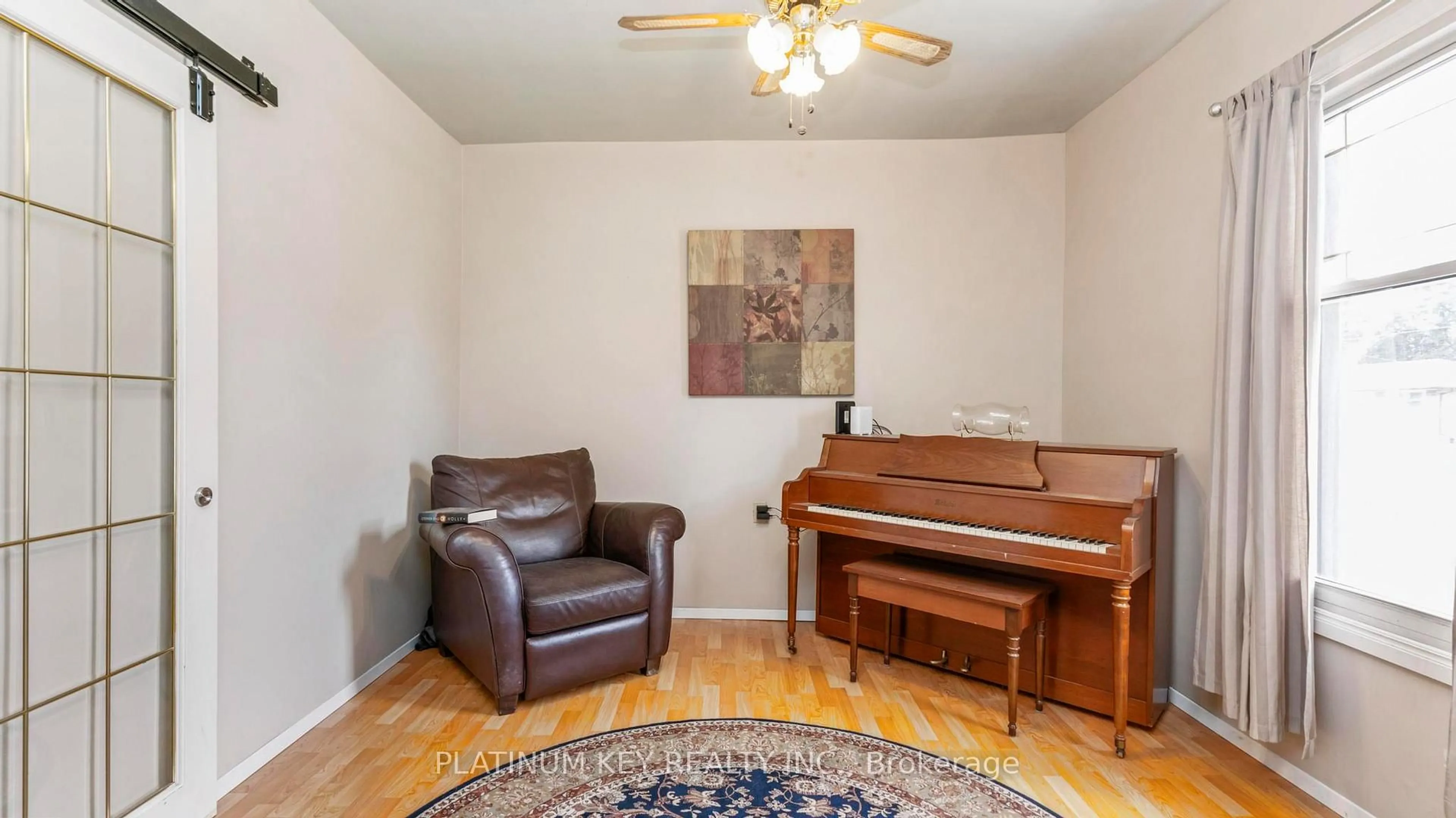 Living room with furniture, wood/laminate floor for 41 Queen St, Strathroy-Caradoc Ontario N7G 2H5