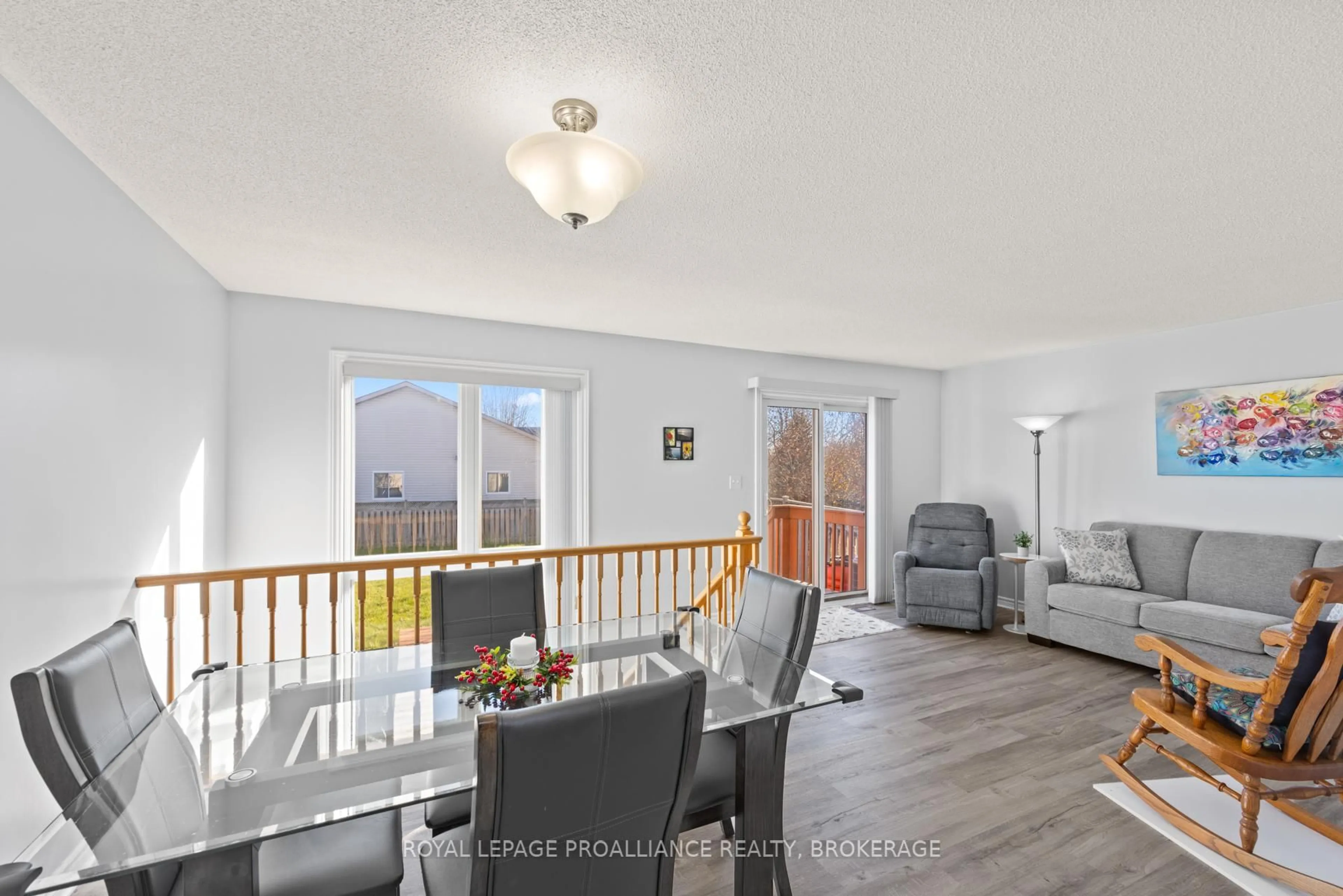 Living room with furniture, wood/laminate floor for 582 Heritage Crt, Kingston Ontario K7M 9C9