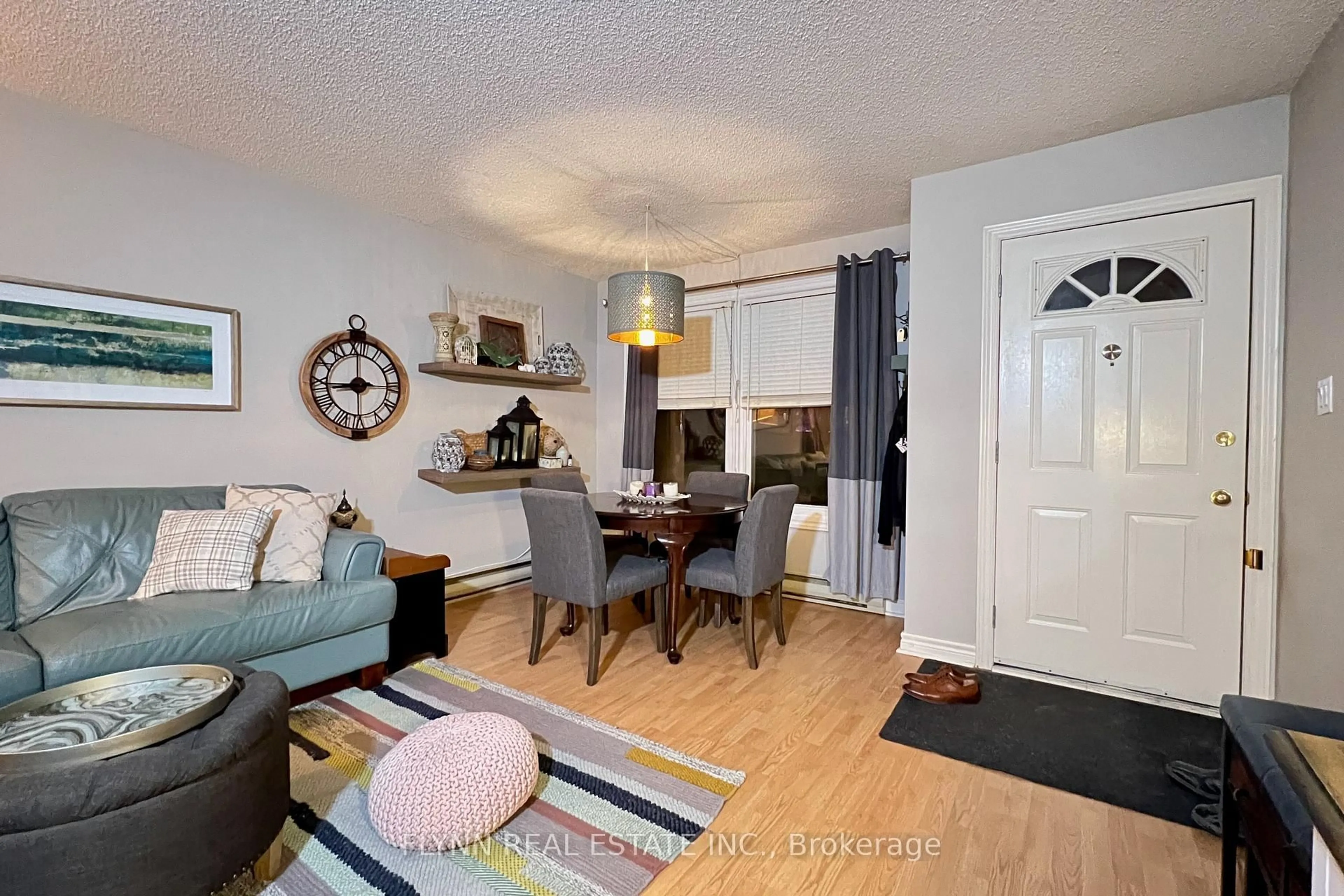 Living room with furniture, wood/laminate floor for 2 Walnut St #105, St. Catharines Ontario L2T 1H3