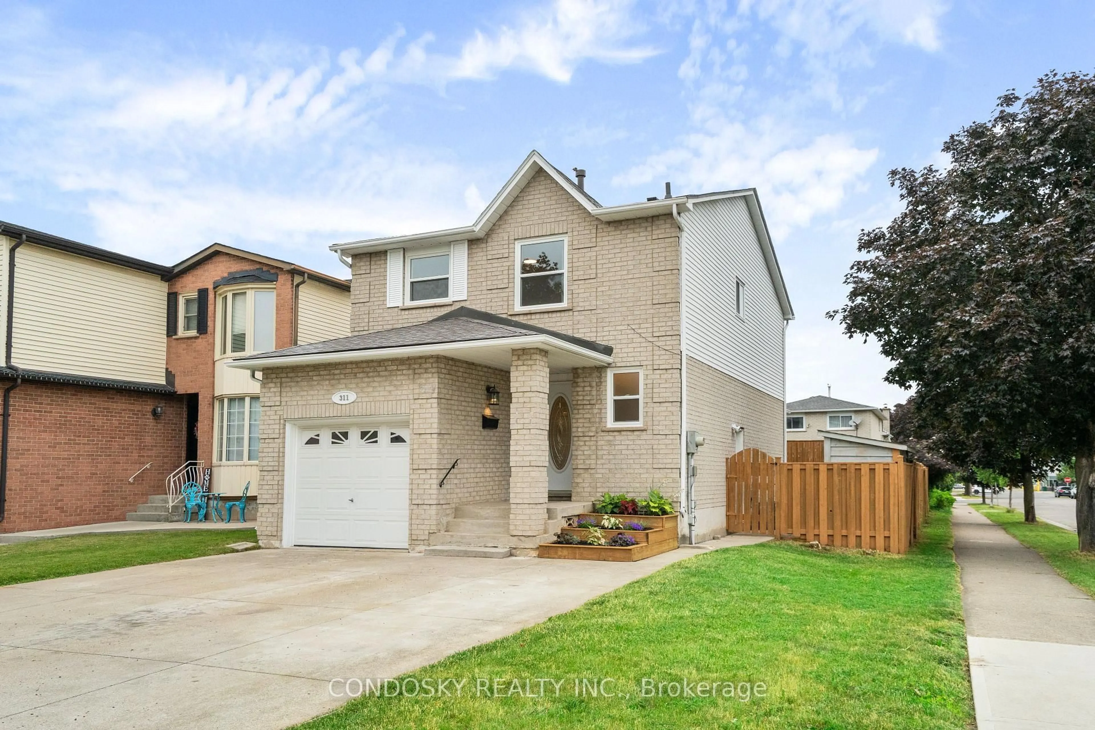 Home with brick exterior material, street for 311 Macintosh Dr, Hamilton Ontario L8E 3Z6