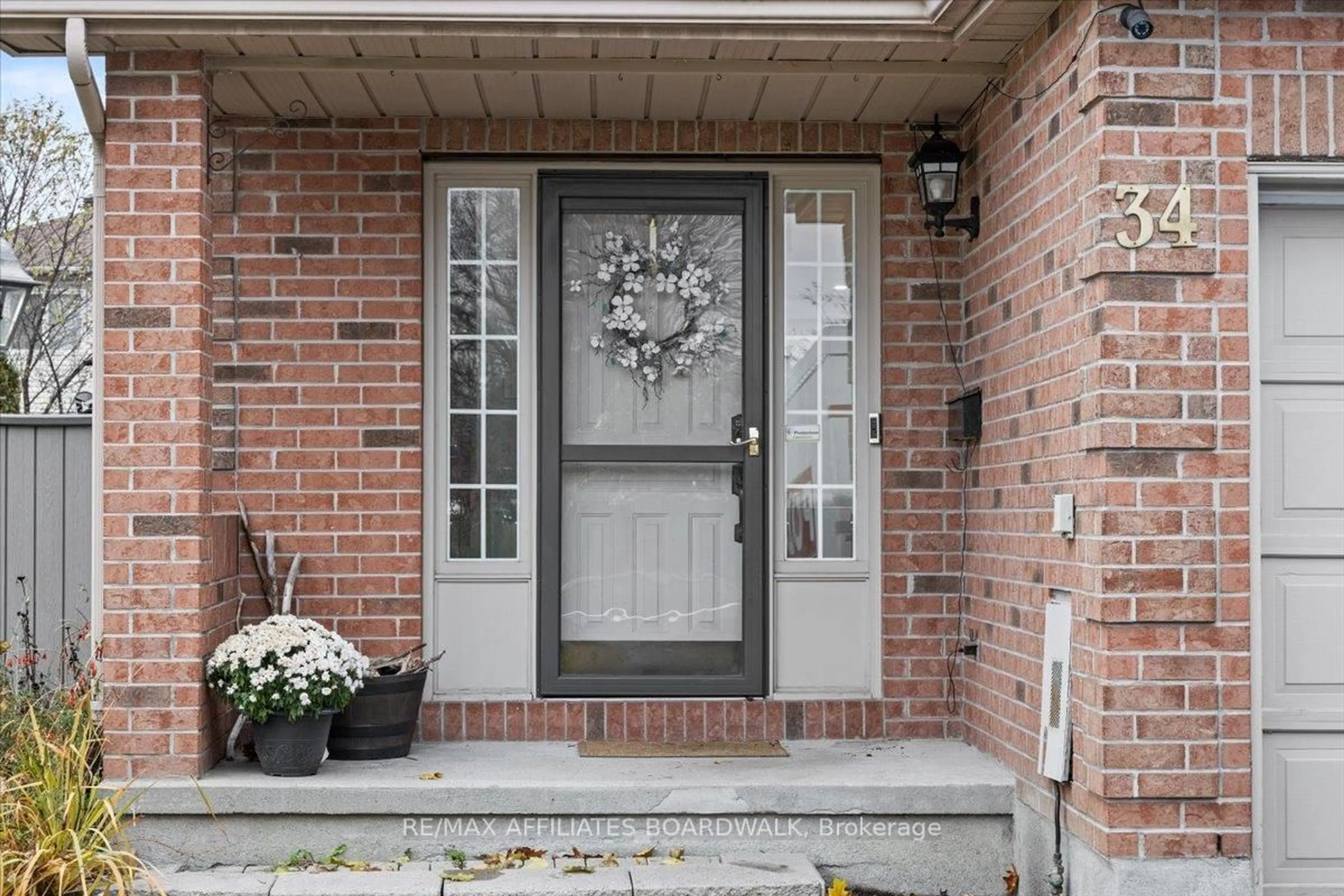 Home with brick exterior material, street for 34 Woodgate Way, Ottawa Ontario K2J 4C9