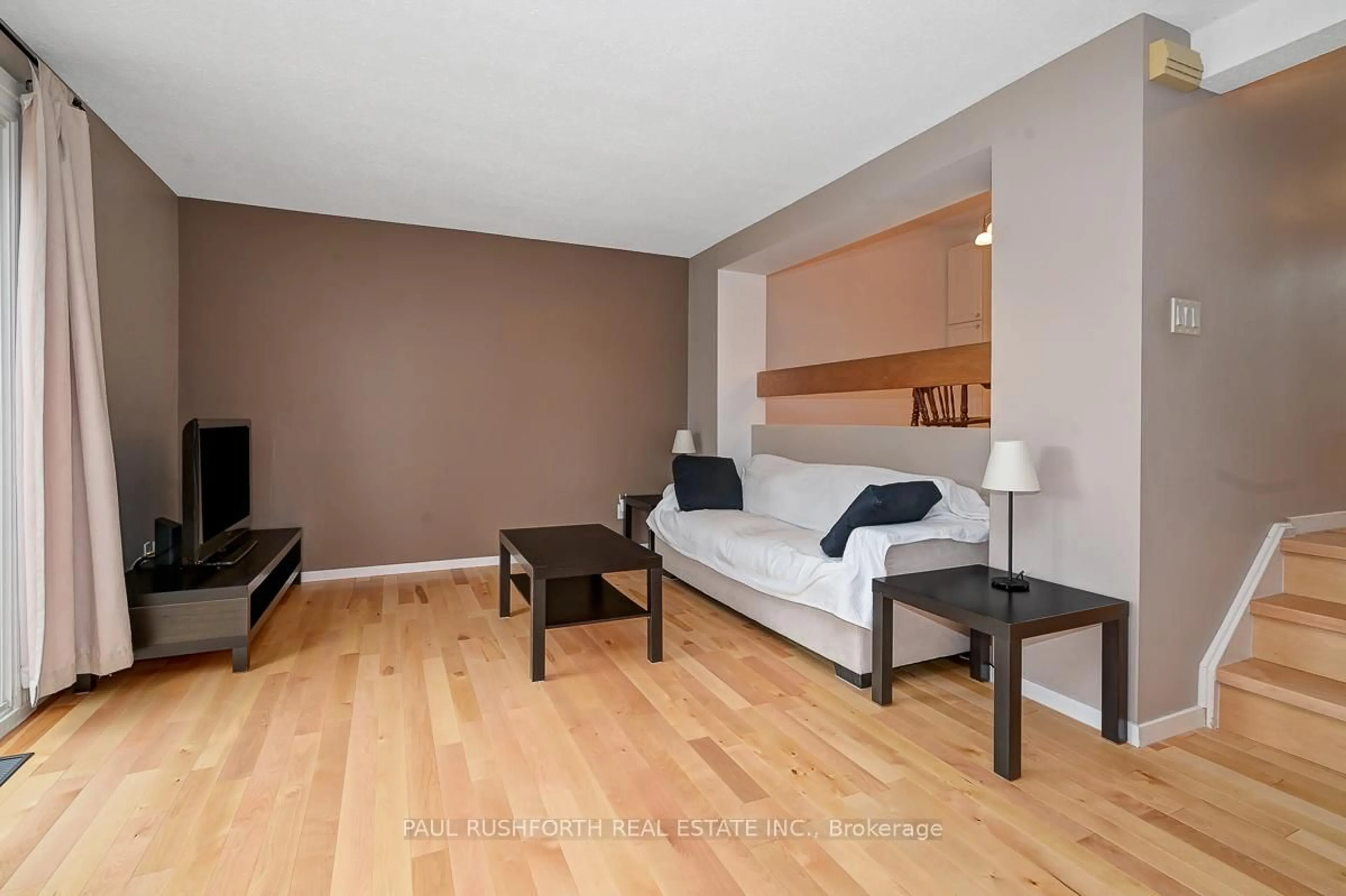 Living room with furniture, wood/laminate floor for 1742 Lamoureux Dr #C, Orleans Ontario K1E 2N2