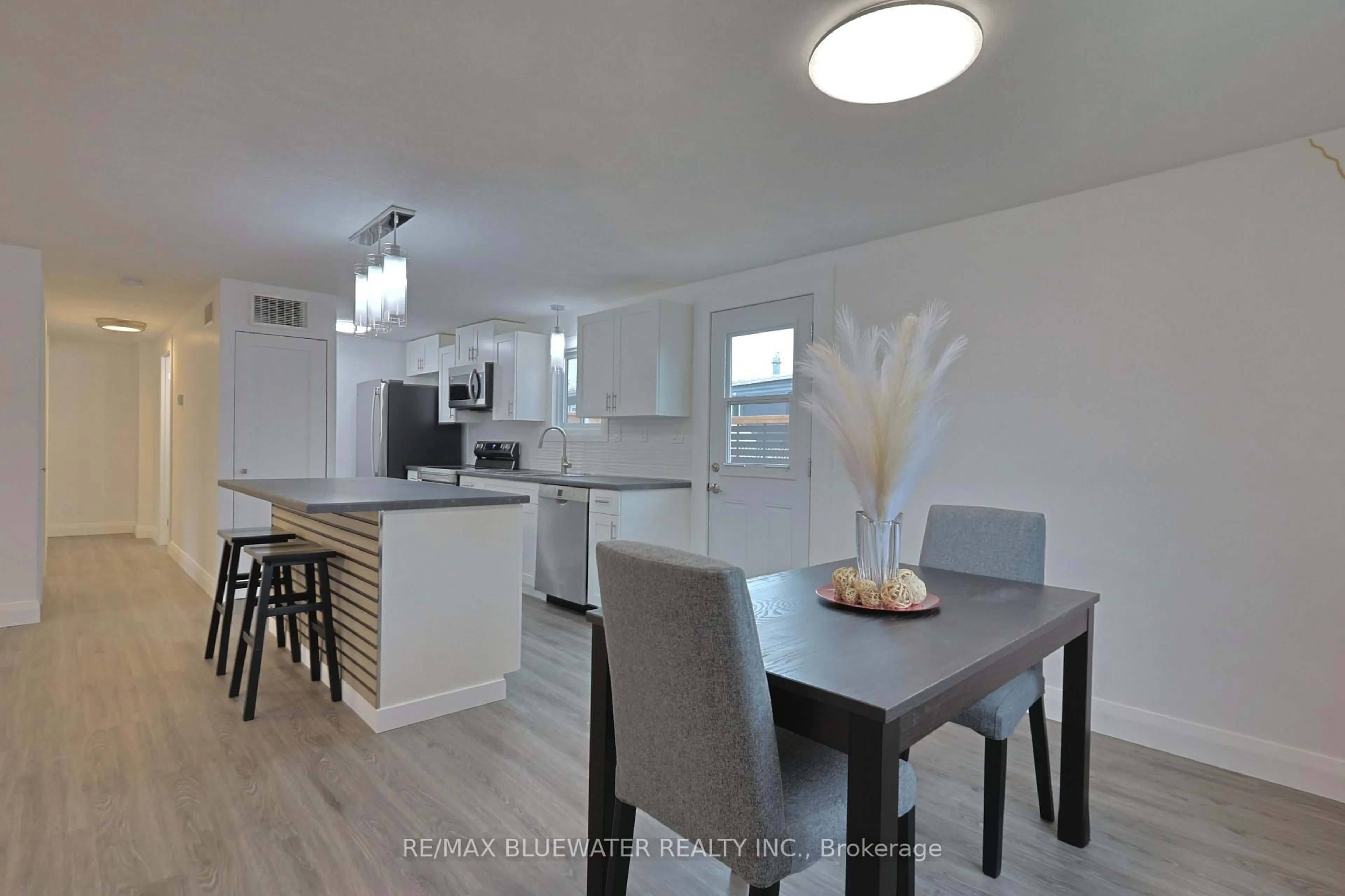 Open concept kitchen, wood/laminate floor for 46 St Andrews Pl, South Huron Ontario N0M 1T0