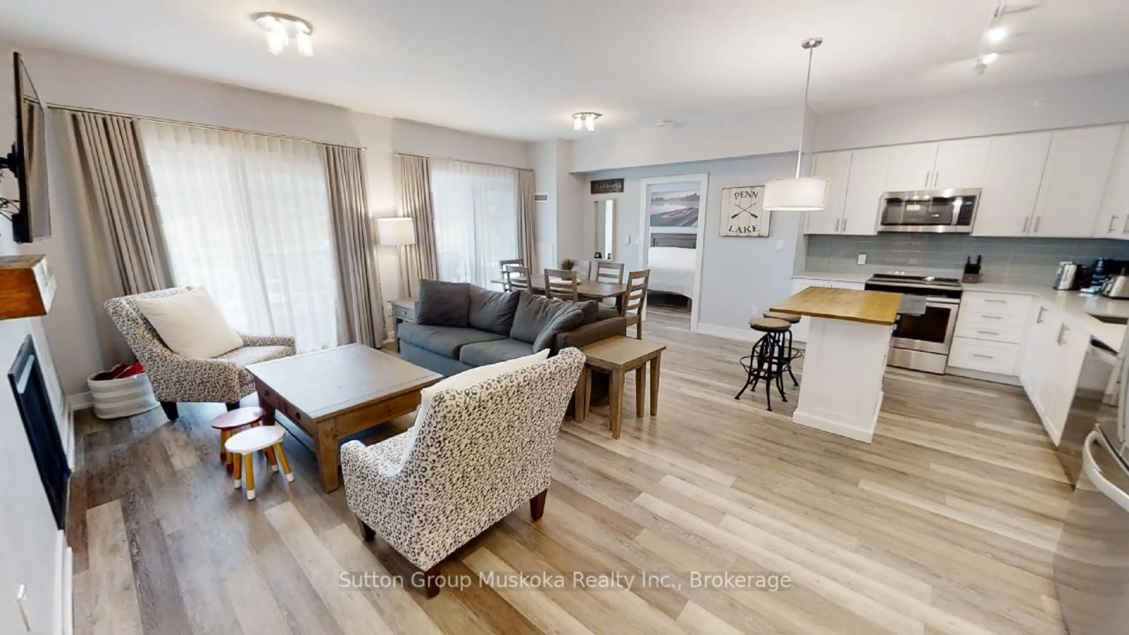 Living room with furniture, wood/laminate floor for 25 Pen Lake Point Rd #318, Huntsville Ontario P1H 2E8