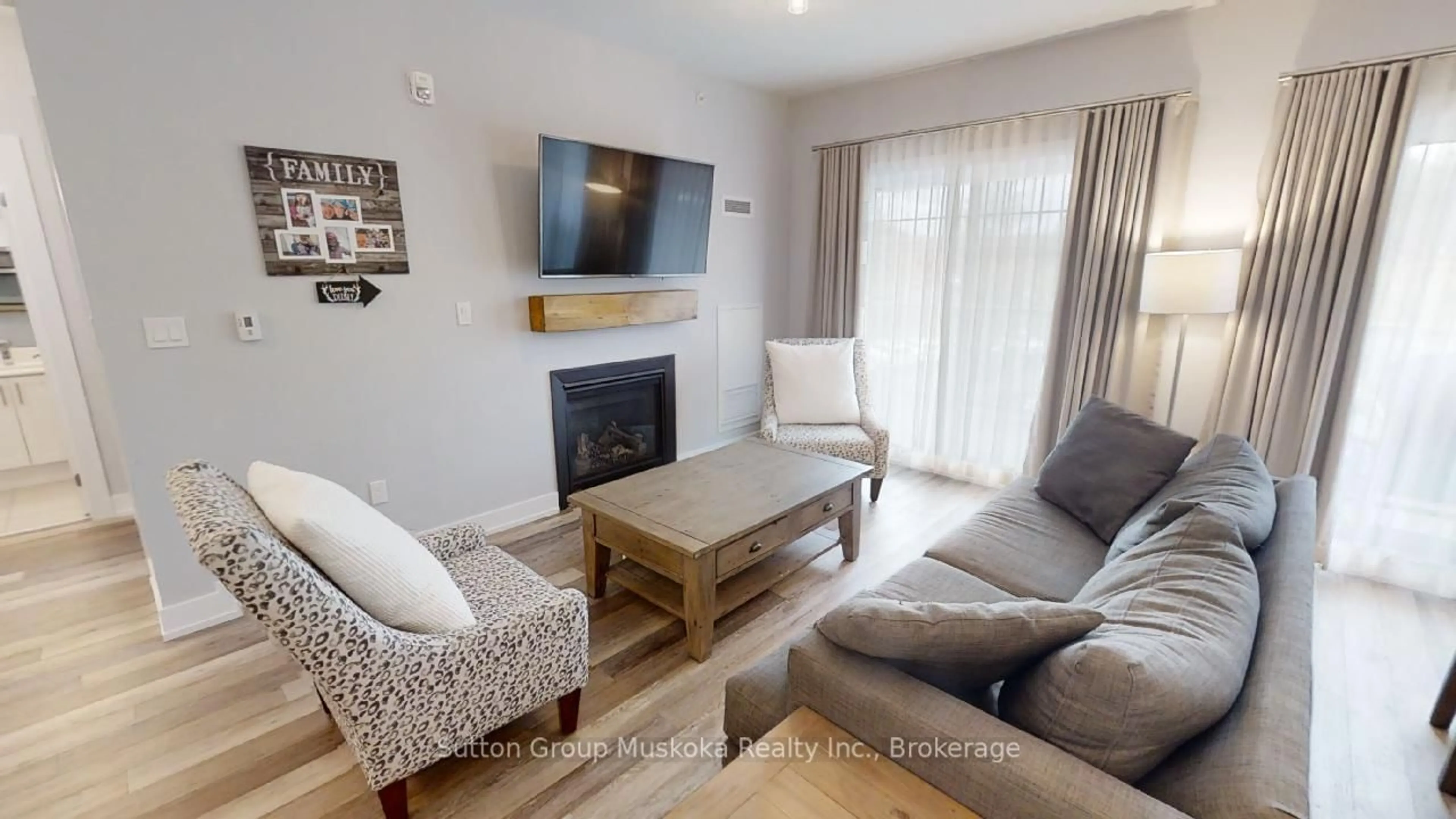 Living room with furniture, wood/laminate floor for 25 Pen Lake Point Rd #318, Huntsville Ontario P1H 2E8