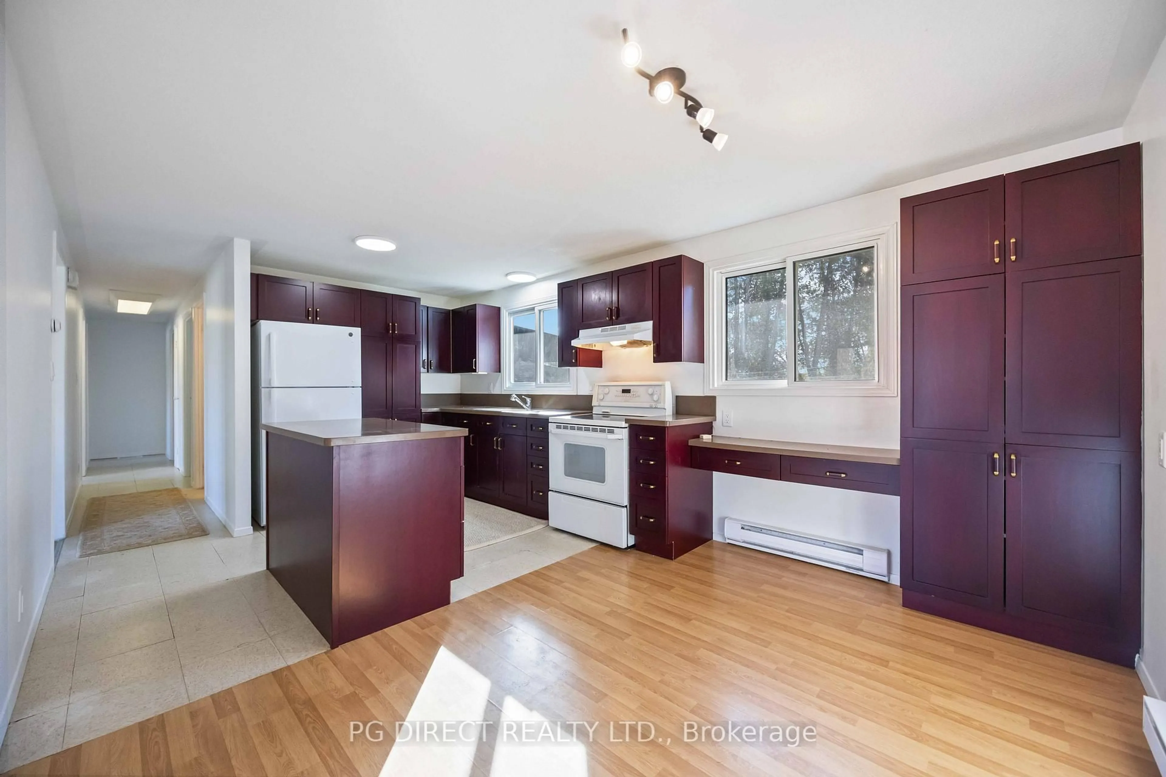Open concept kitchen, wood/laminate floor for 100 Francis St, Kawartha Lakes Ontario K0M 1N0