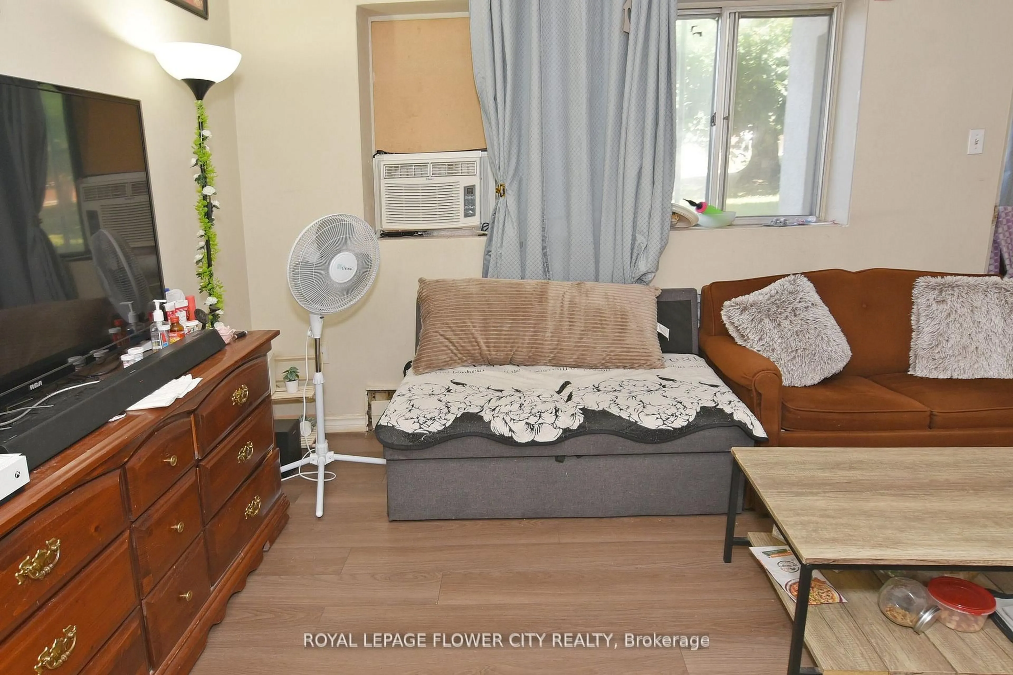 Living room with furniture, wood/laminate floor for 1176 Hamilton Rd #105, London East Ontario N5W 1A9
