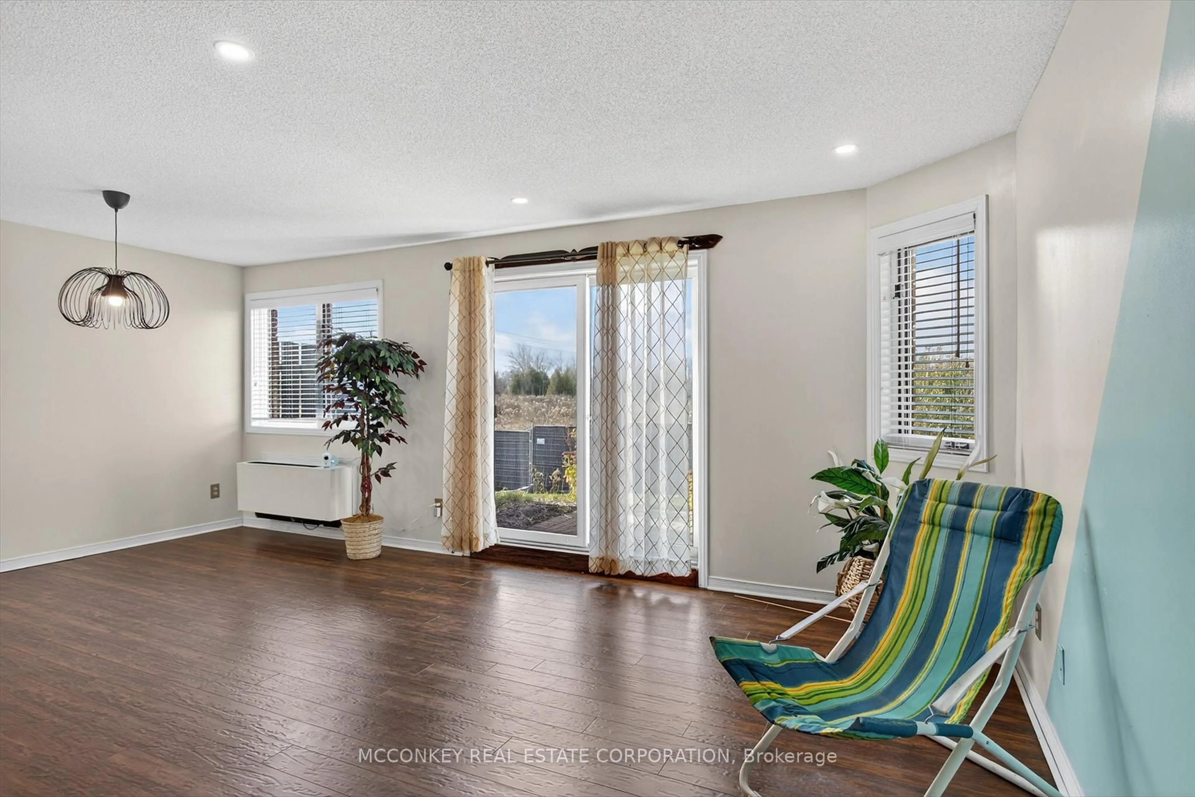 Living room with furniture, wood/laminate floor for 36 Champlain Cres #26, Peterborough Ontario K9L 1T1