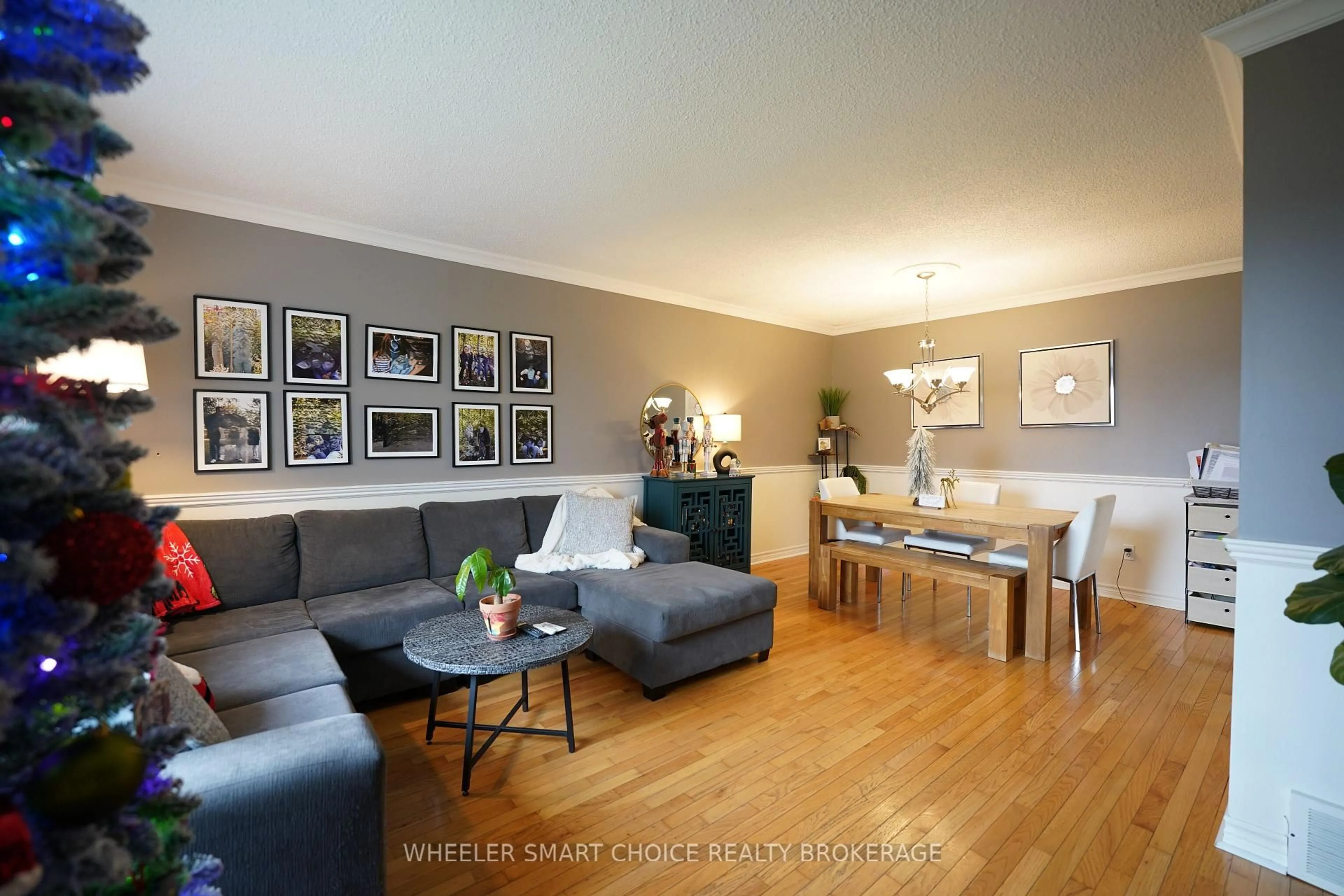 Living room with furniture, wood/laminate floor for 402 Cline Ave, Cornwall Ontario K6J 5M8