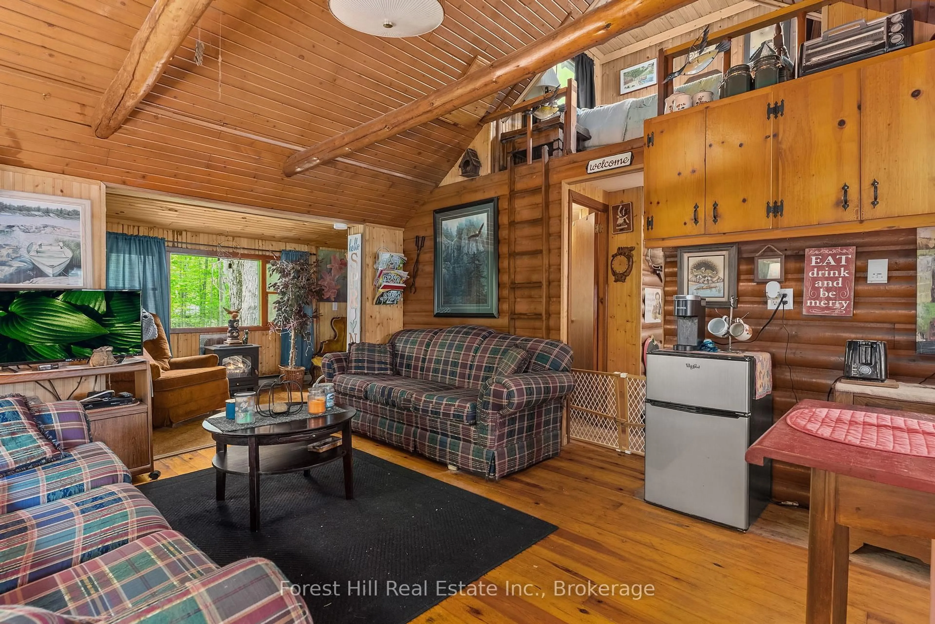 Living room with furniture, wood/laminate floor for 1067 West Black Lake Rd, Muskoka Lakes Ontario P0C 1M0
