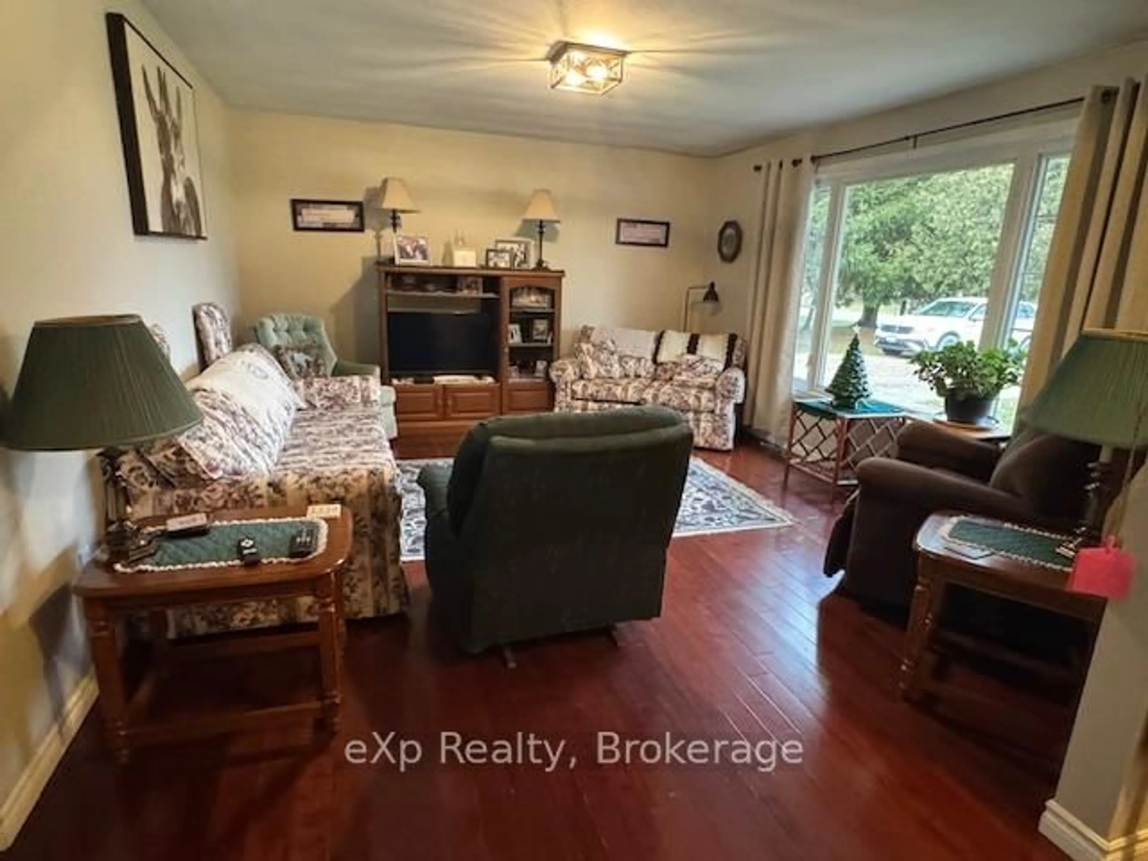 Living room with furniture, wood/laminate floor for 392158 Grey Road 109 Rd, Southgate Ontario N0G 2A0