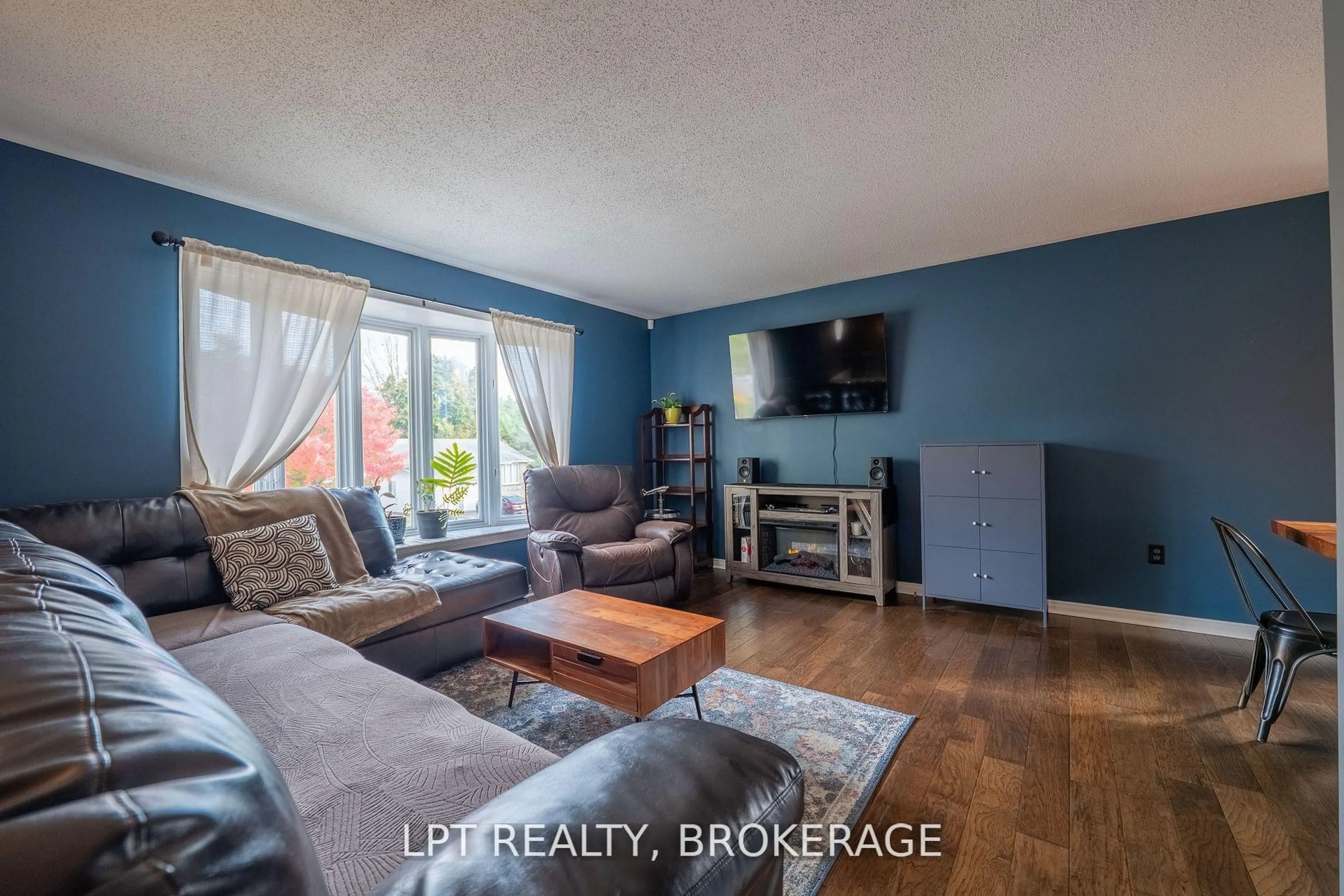 Living room with furniture, wood/laminate floor for 697 Macdonald Dr, Gananoque Ontario K7G 3C4