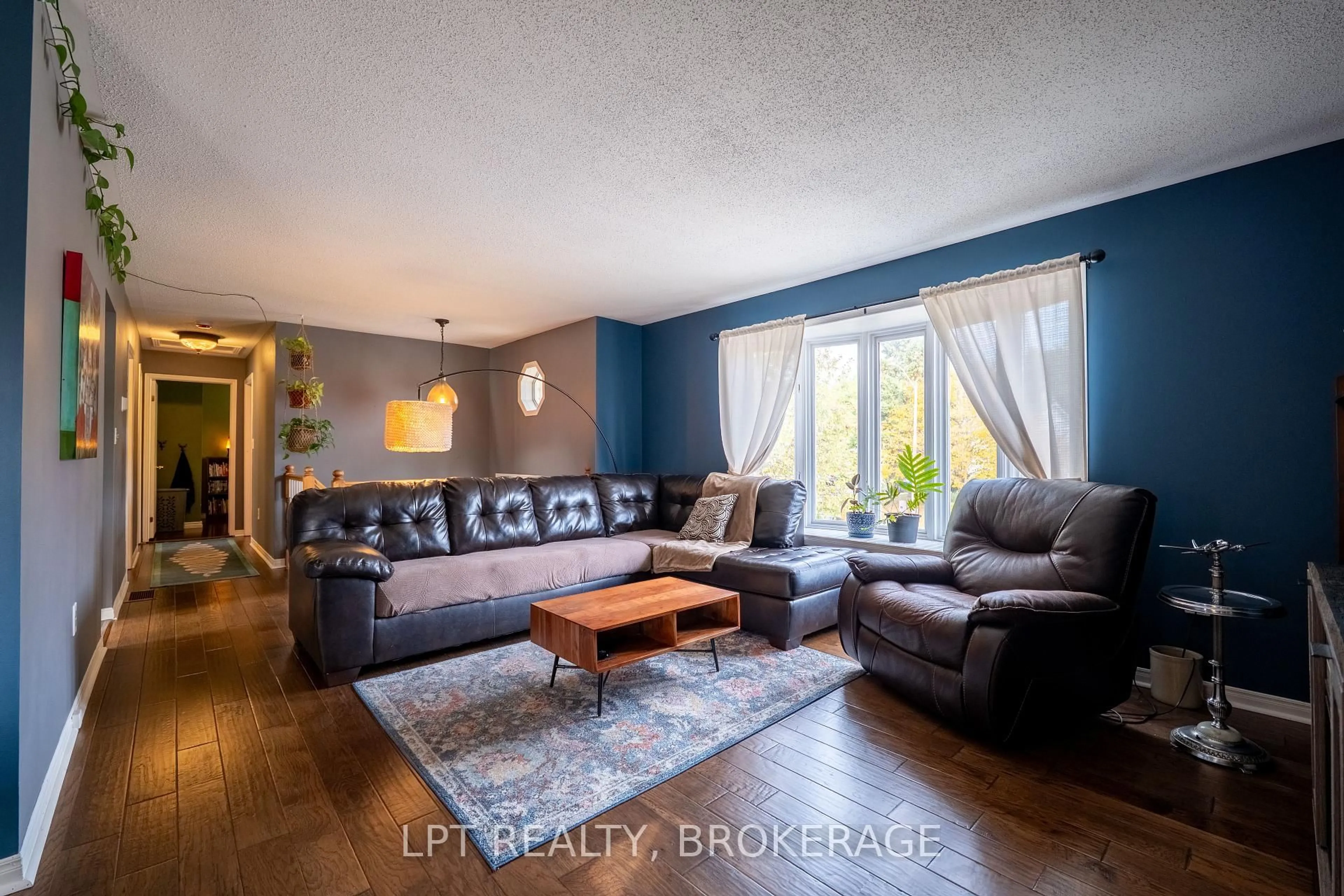 Living room with furniture, wood/laminate floor for 697 Macdonald Dr, Gananoque Ontario K7G 3C4