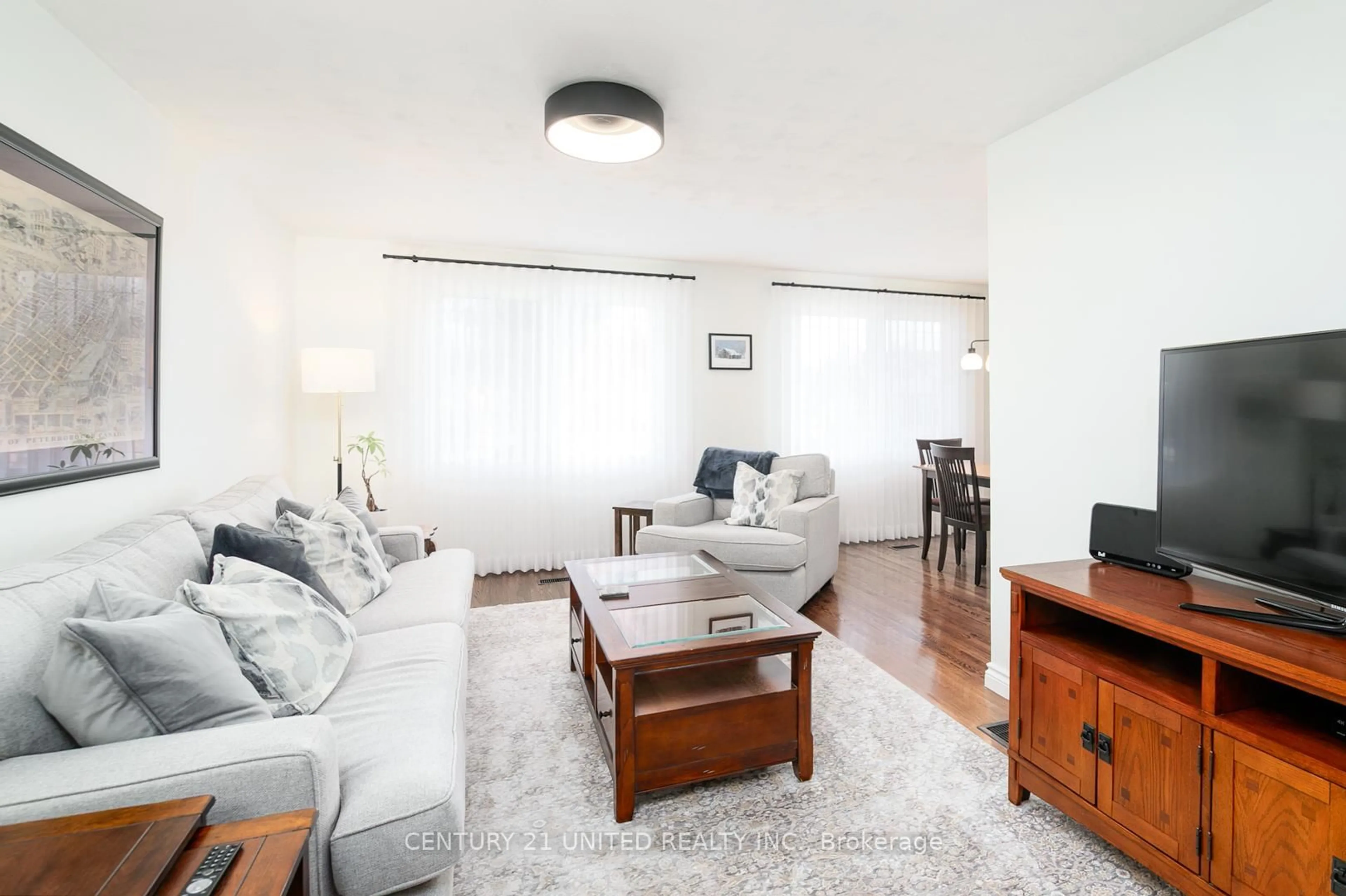 Living room with furniture, wood/laminate floor for 1002 Albany Crt, Peterborough Ontario K9J 1J2