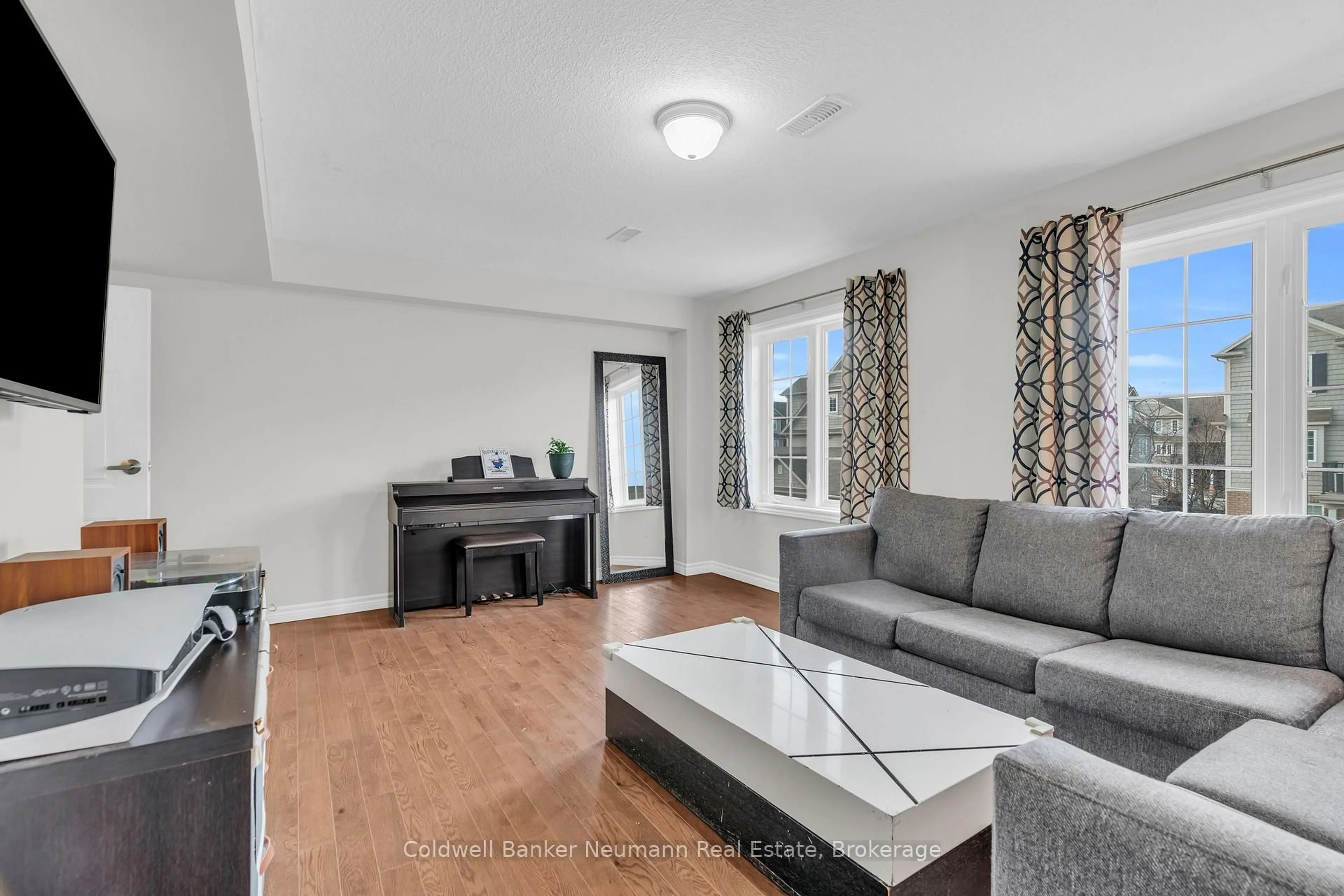 Living room with furniture, wood/laminate floor for 644 Woodlawn Rd #A, Guelph Ontario N1E 0K4