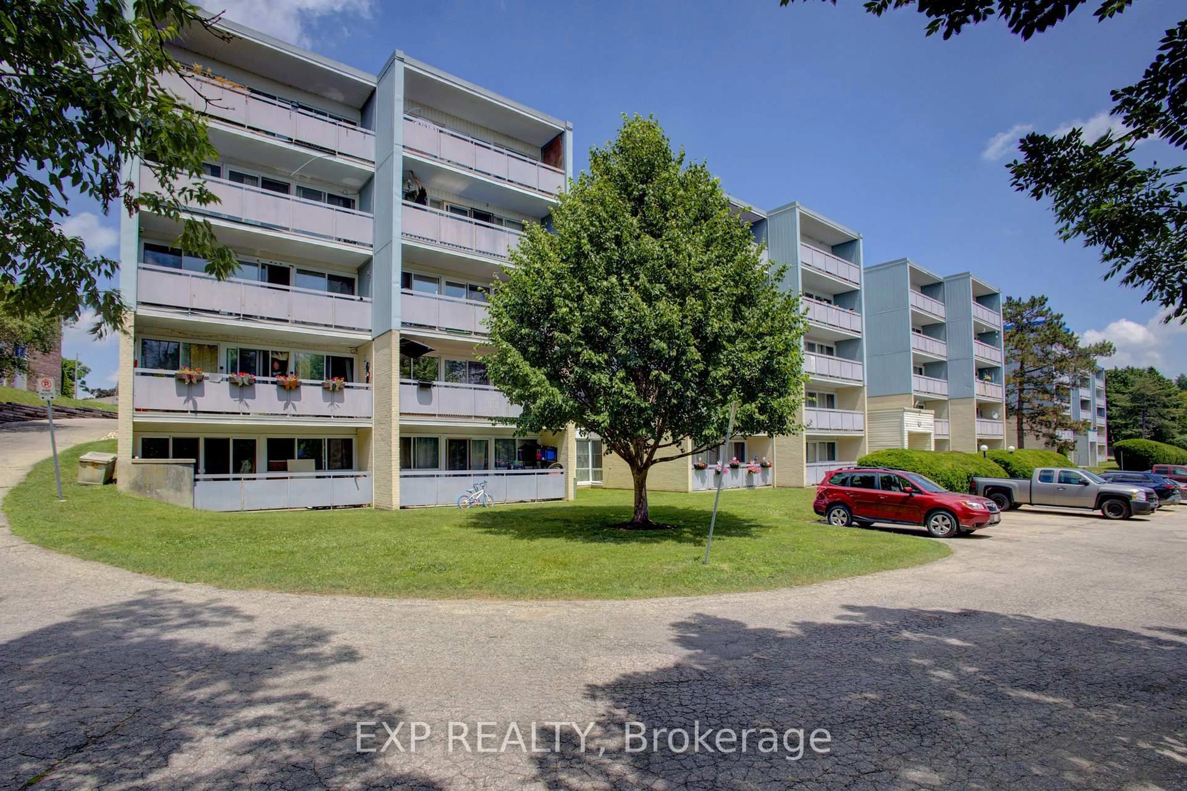 A pic from outside/outdoor area/front of a property/back of a property/a pic from drone, street for 91 Conroy Cres #202, Guelph Ontario N1G 2V5