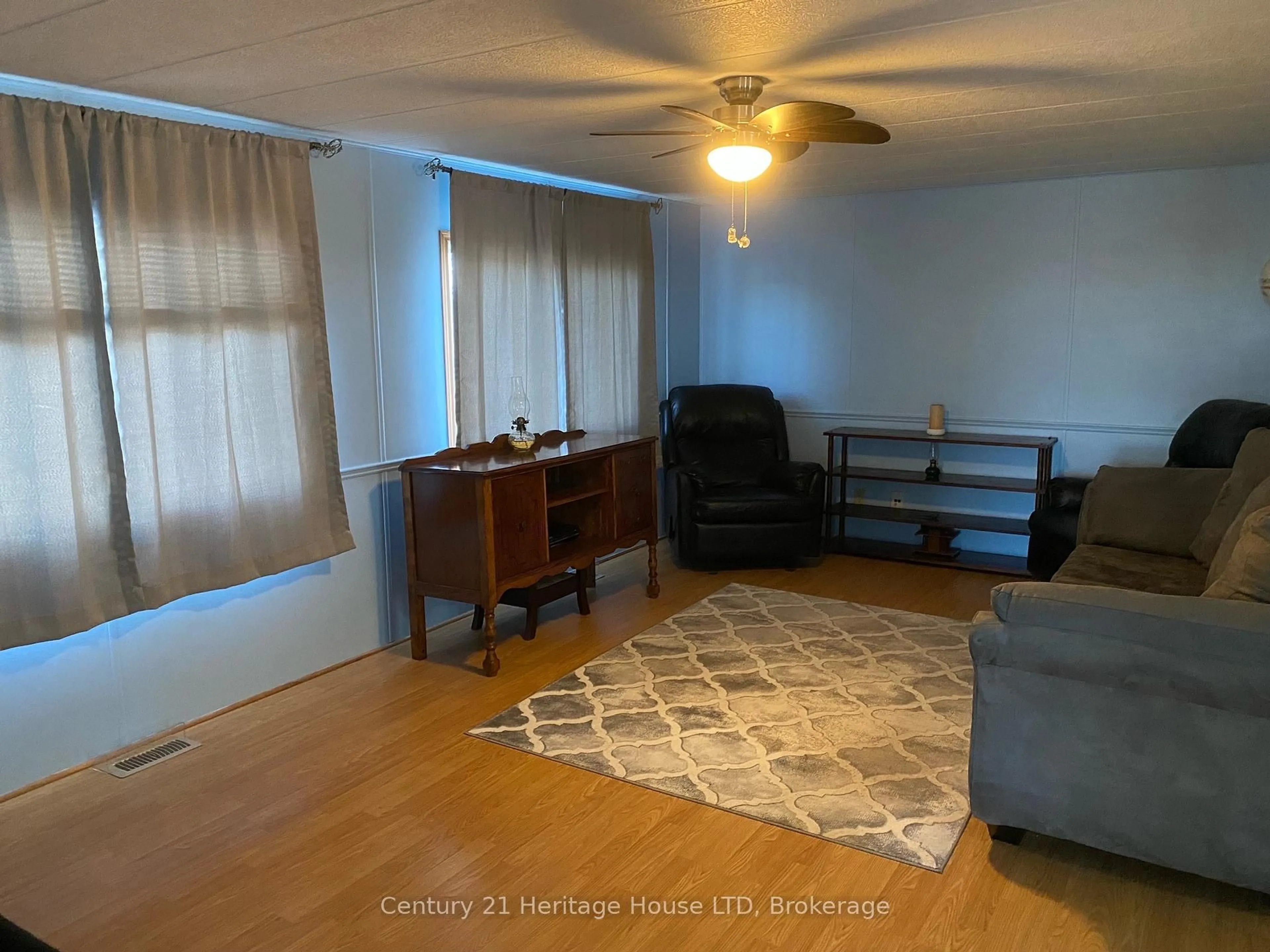 Living room with furniture, wood/laminate floor for 3033 Townline Rd #187, Fort Erie Ontario L0S 1S1