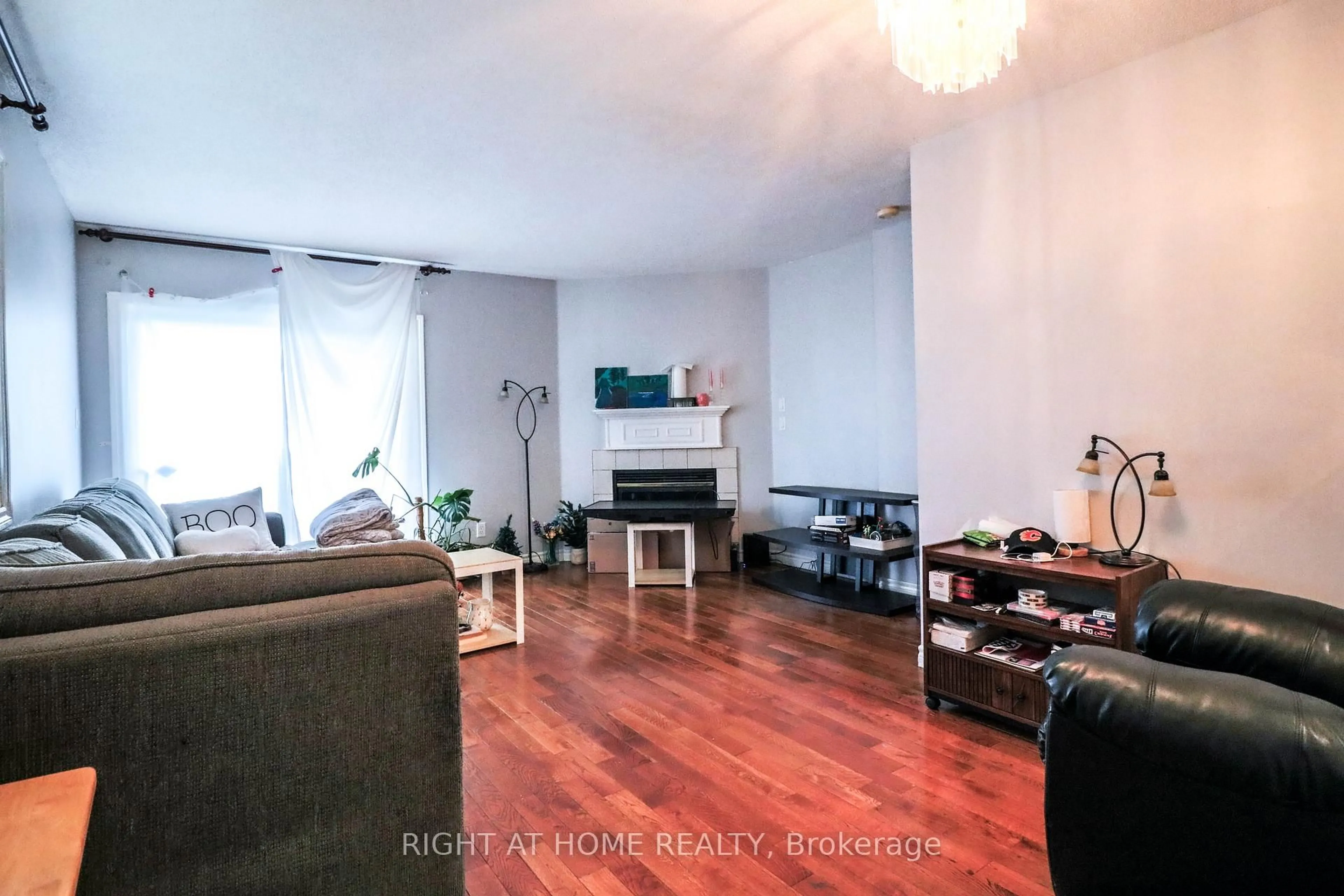 Living room with furniture, wood/laminate floor for 1901 Hampstead Pl, Ottawa Ontario K1V 1B3