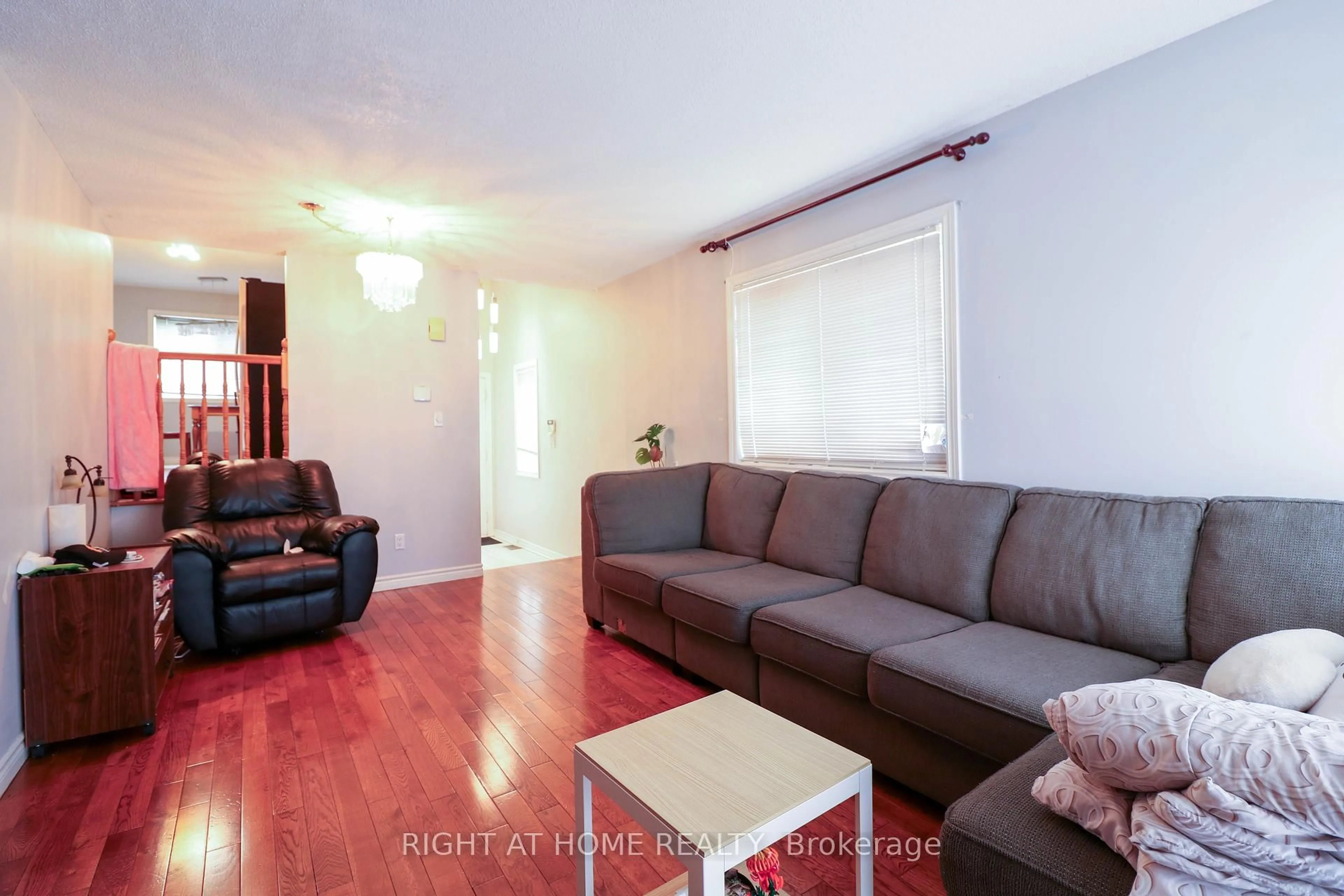 Living room with furniture, wood/laminate floor for 1901 Hampstead Pl, Ottawa Ontario K1V 1B3