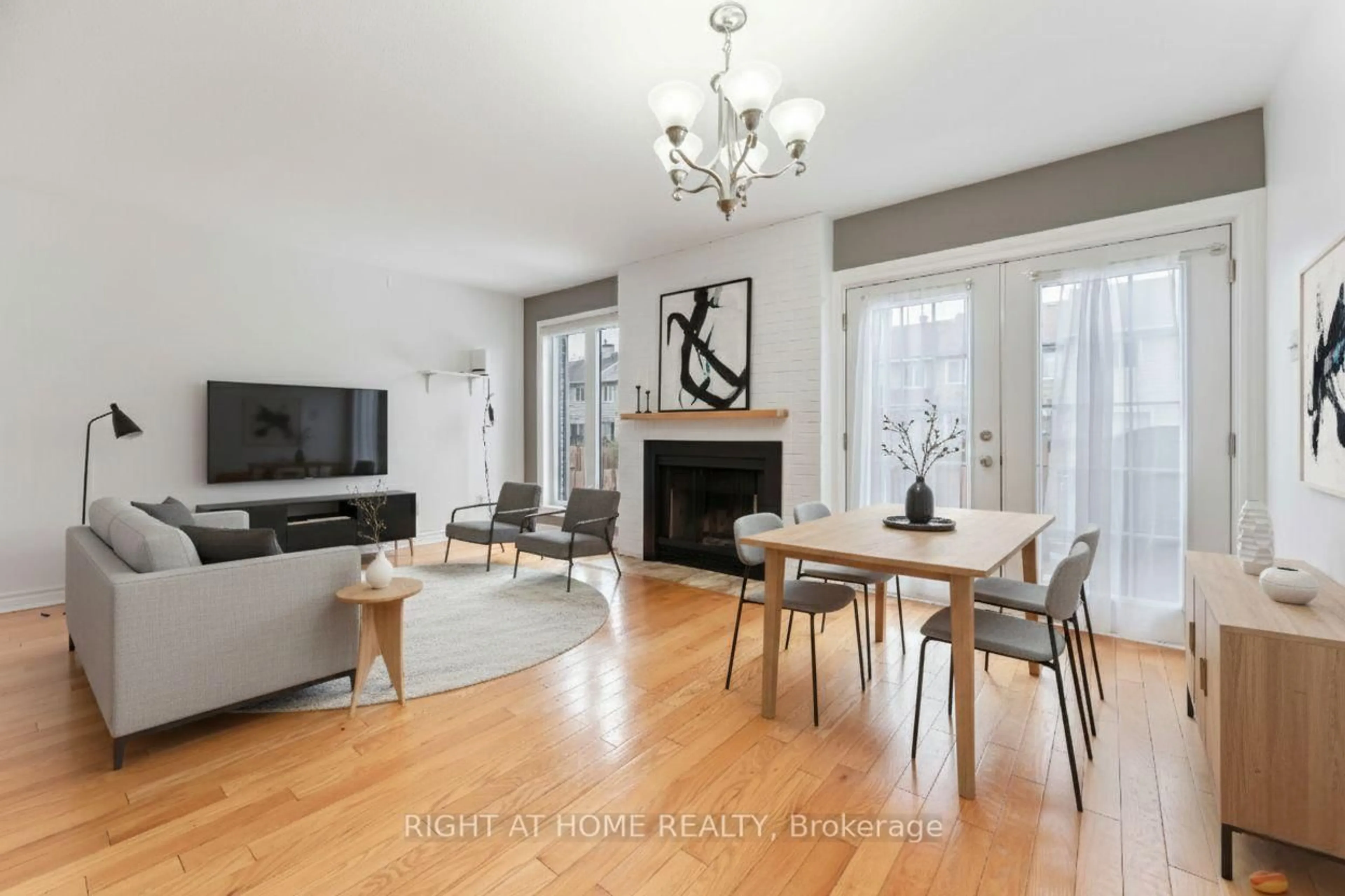 Living room with furniture, wood/laminate floor for 70 Halley St, Barrhaven Ontario K2J 3R3