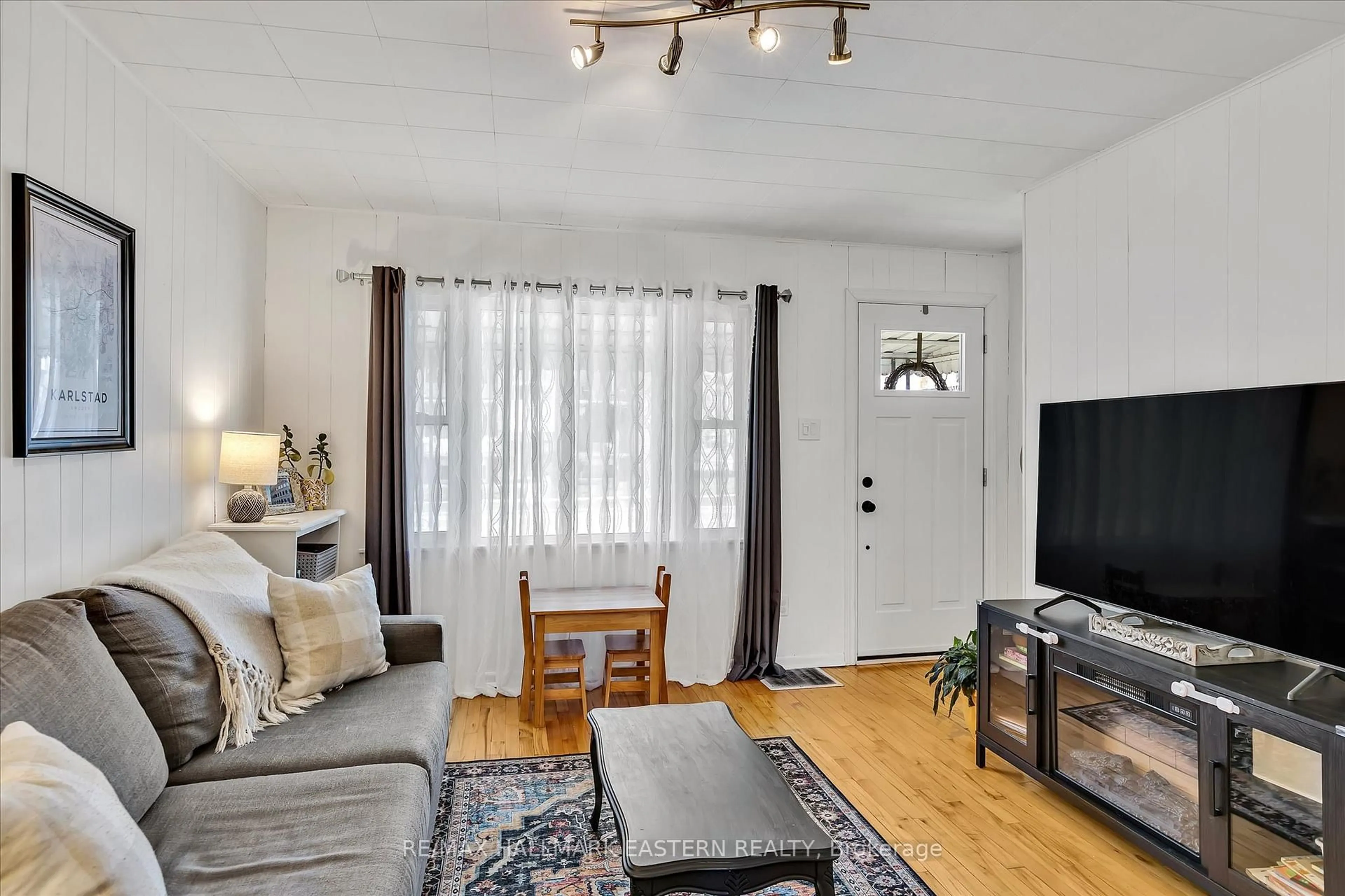 Living room with furniture, wood/laminate floor for 706 Monaghan Rd, Peterborough Ontario K9J 5J8