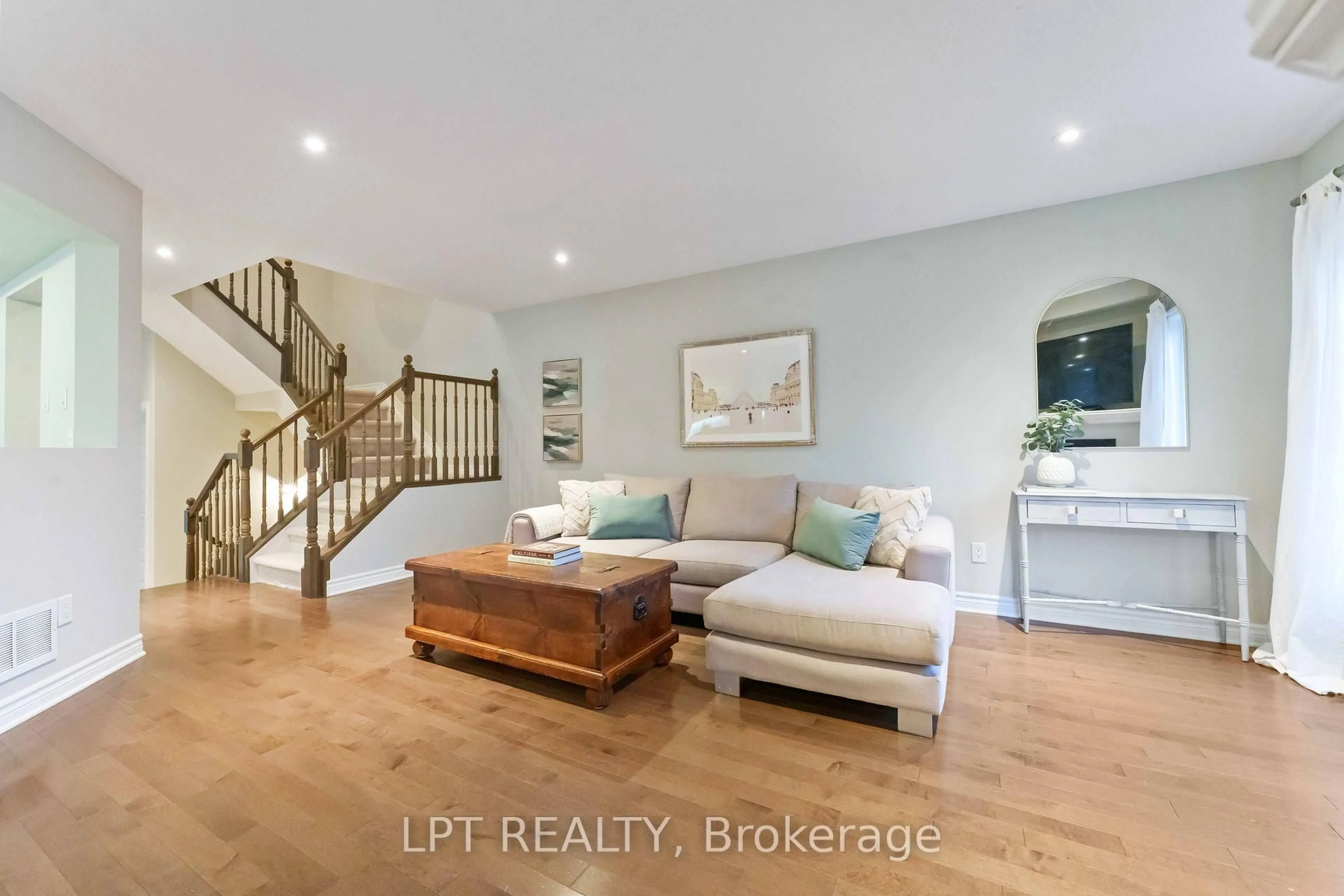 Living room with furniture, wood/laminate floor for 102 Calvington Ave, Ottawa Ontario K2T 0H7