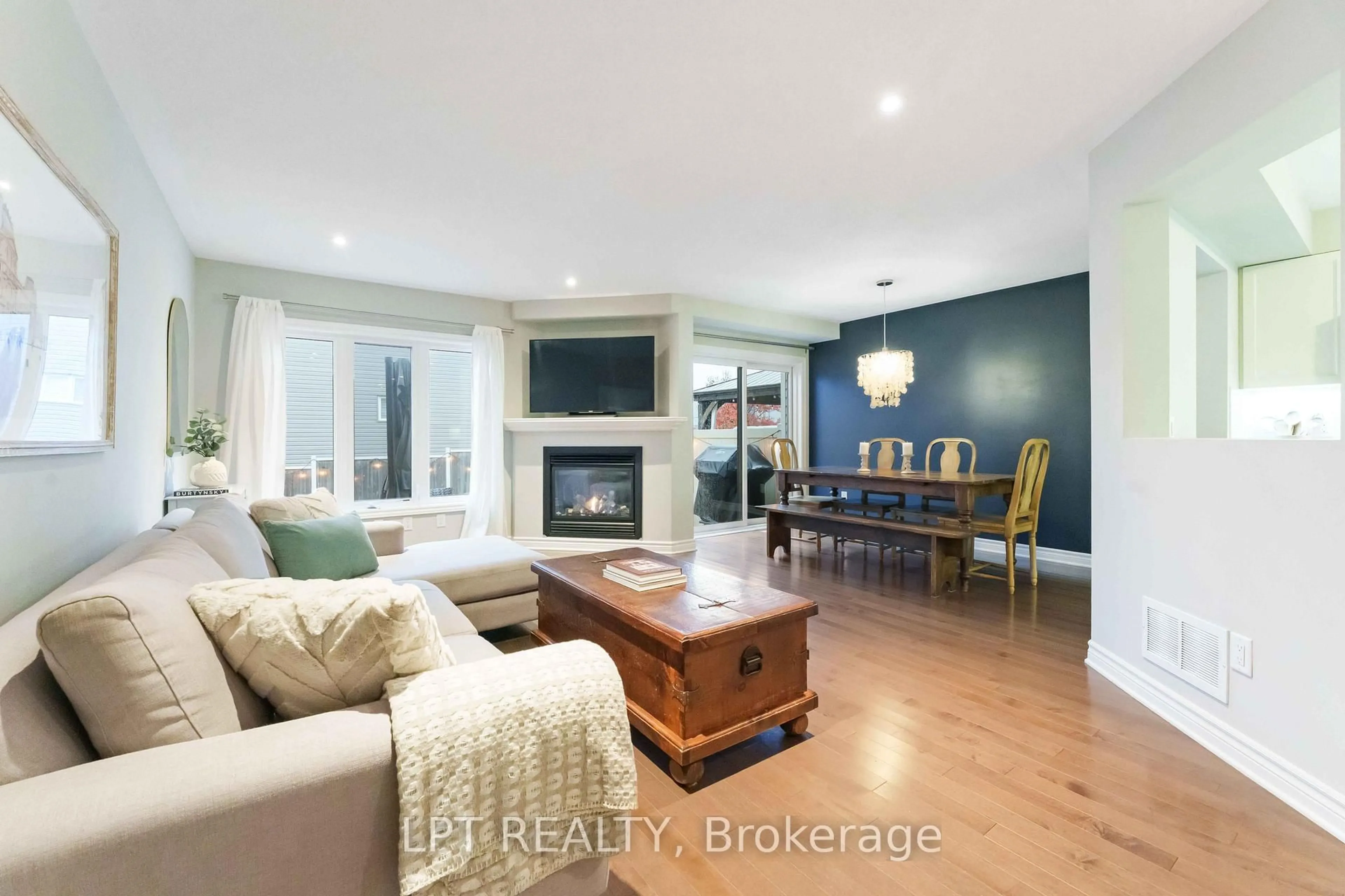 Living room with furniture, wood/laminate floor for 102 Calvington Ave, Ottawa Ontario K2T 0H7