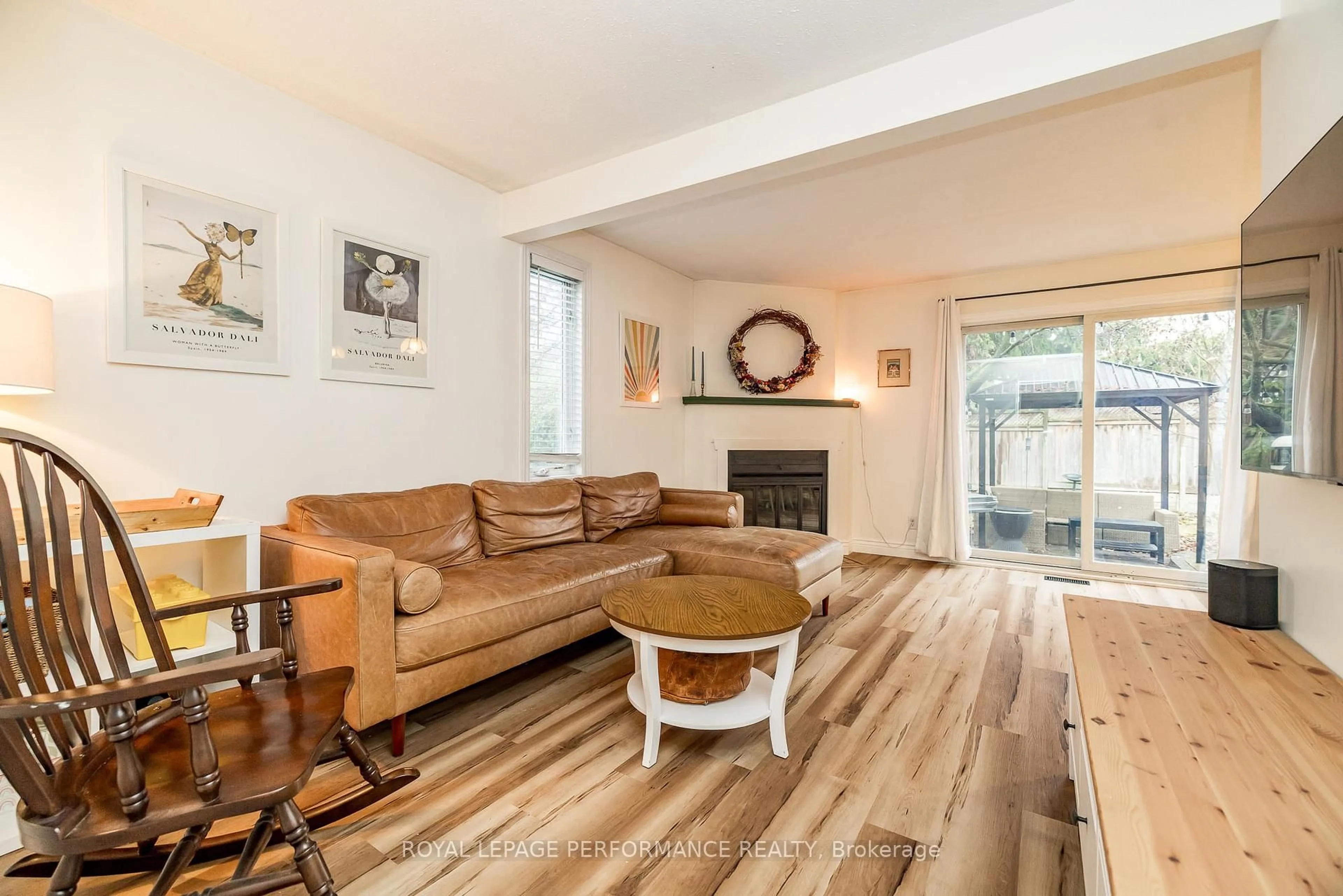 Living room with furniture, wood/laminate floor for 78 Bujold Crt, Ottawa Ontario K2L 3N8