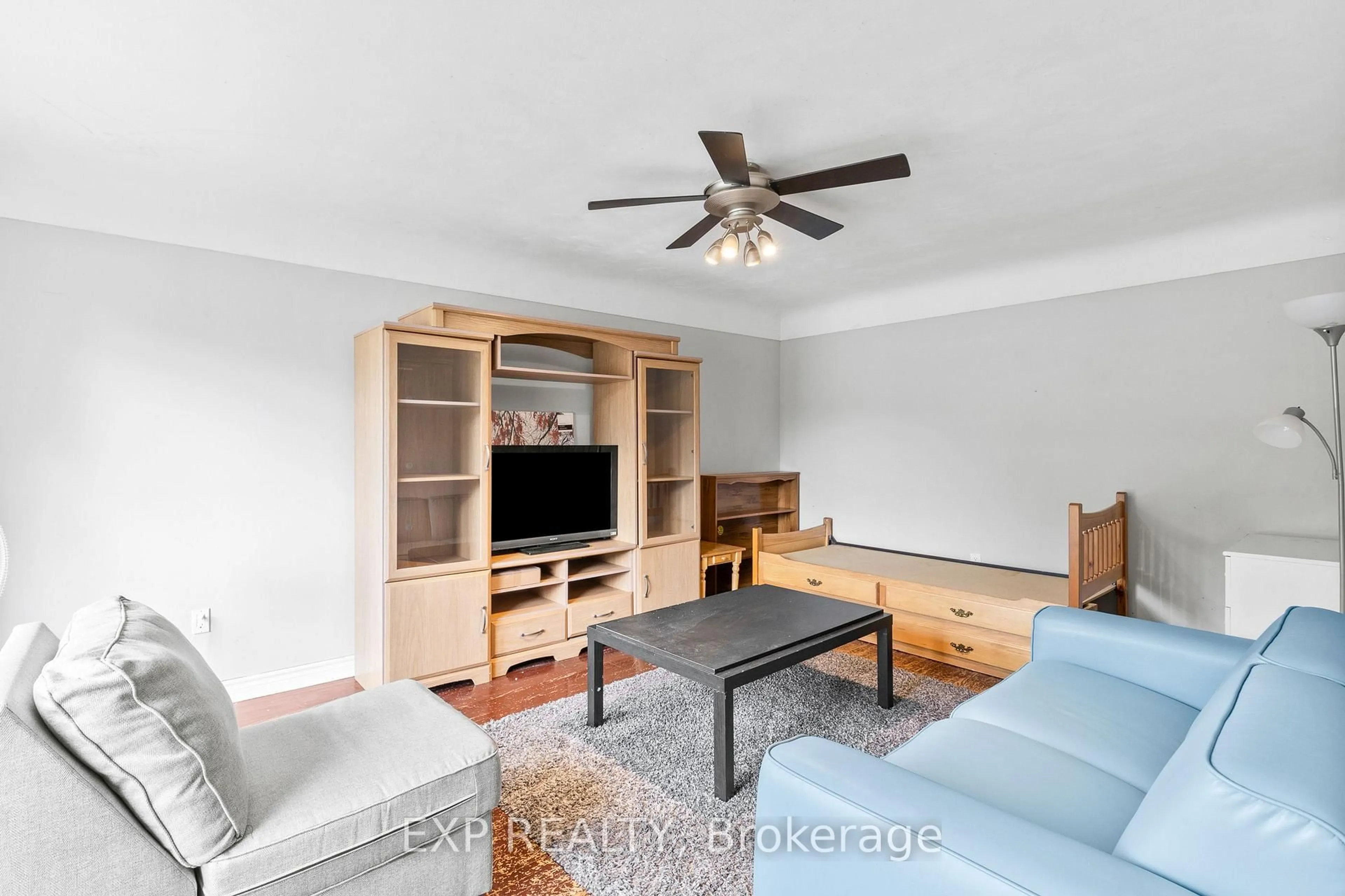 Living room with furniture, wood/laminate floor for 61 Radford St, Hamilton Ontario L8S 3E5