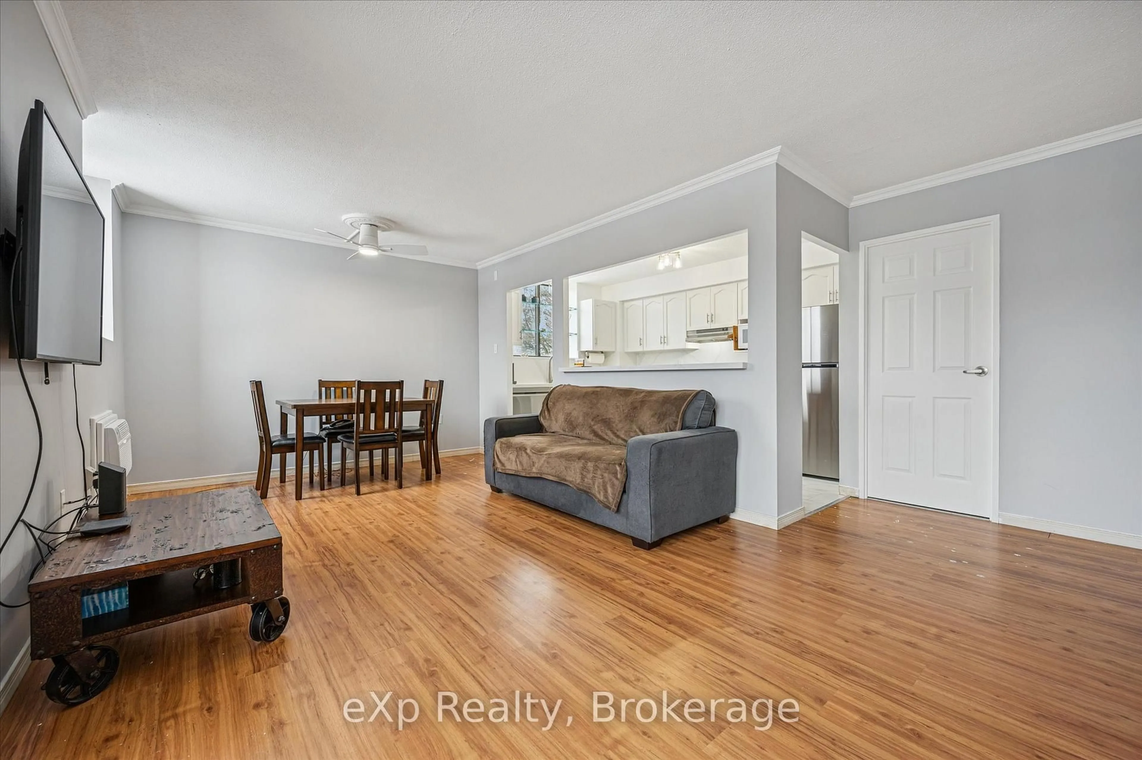 Living room with furniture, wood/laminate floor for 93 Westwood Rd #301, Guelph Ontario N1H 7J7