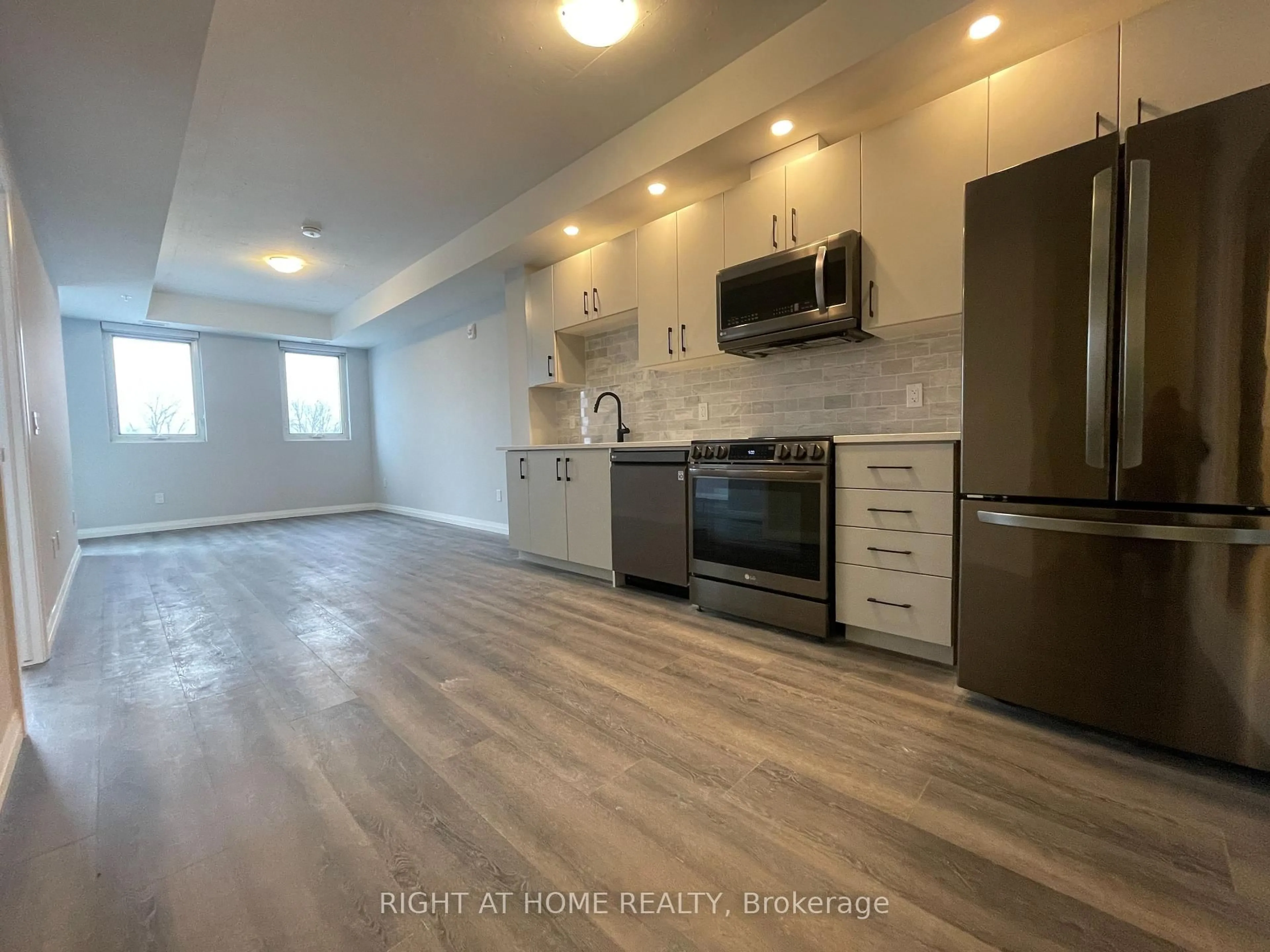 Open concept kitchen, wood/laminate floor for 108 Garment St #312, Kitchener Ontario N2G 2B3