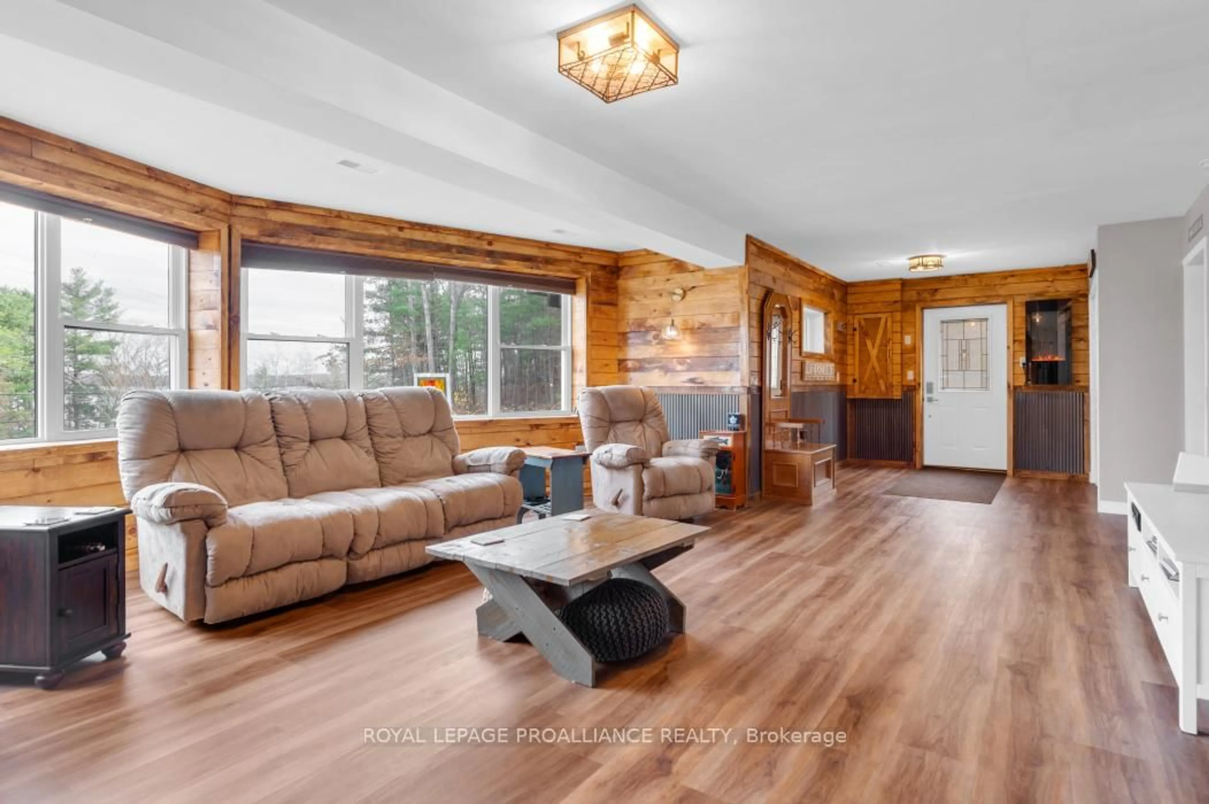 Living room with furniture, wood/laminate floor for 17206 Highway 41, Cloyne Ontario K0H 1K0