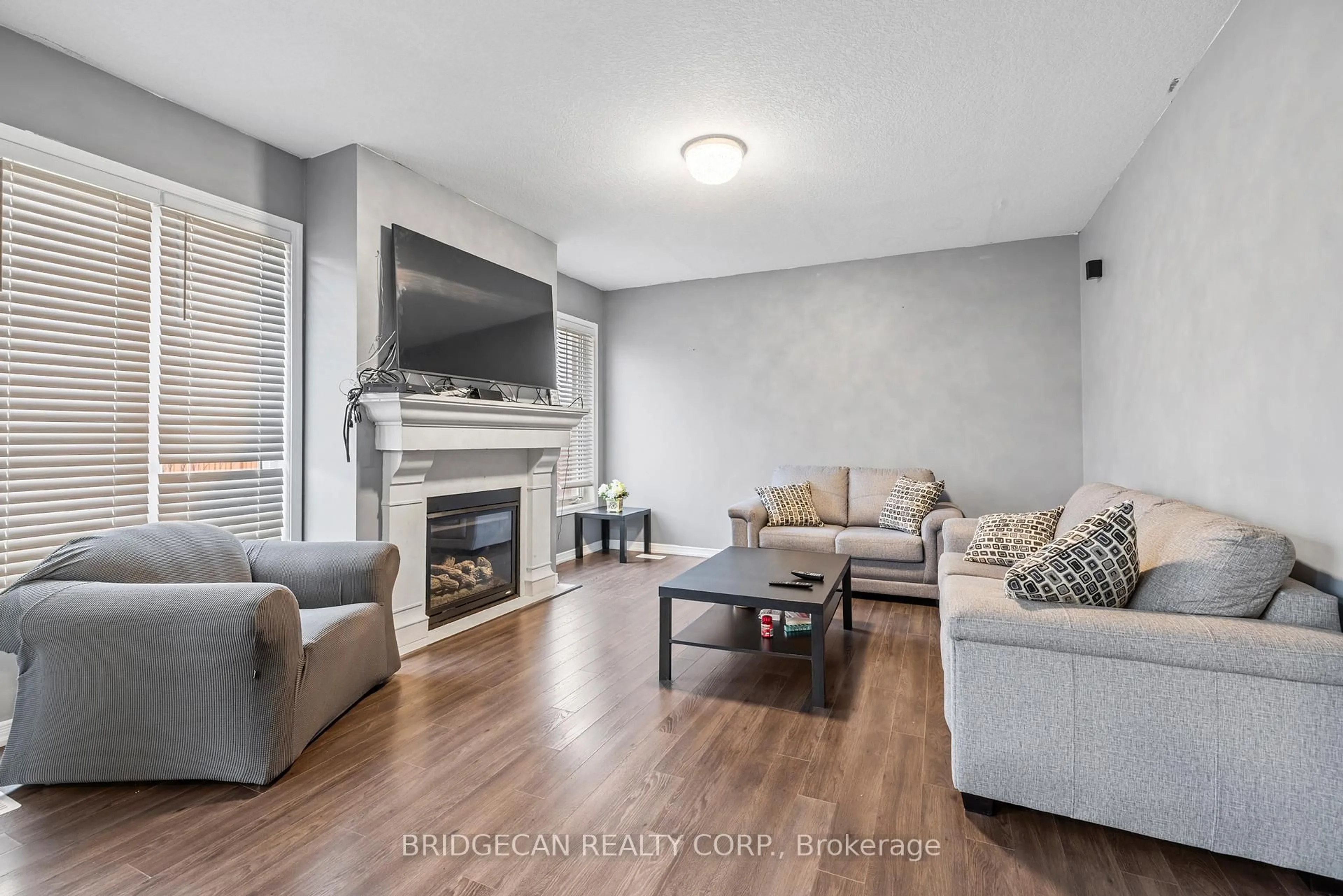 Living room with furniture, wood/laminate floor for 20 Gillespie Dr, Brantford Ontario N3P 0K1