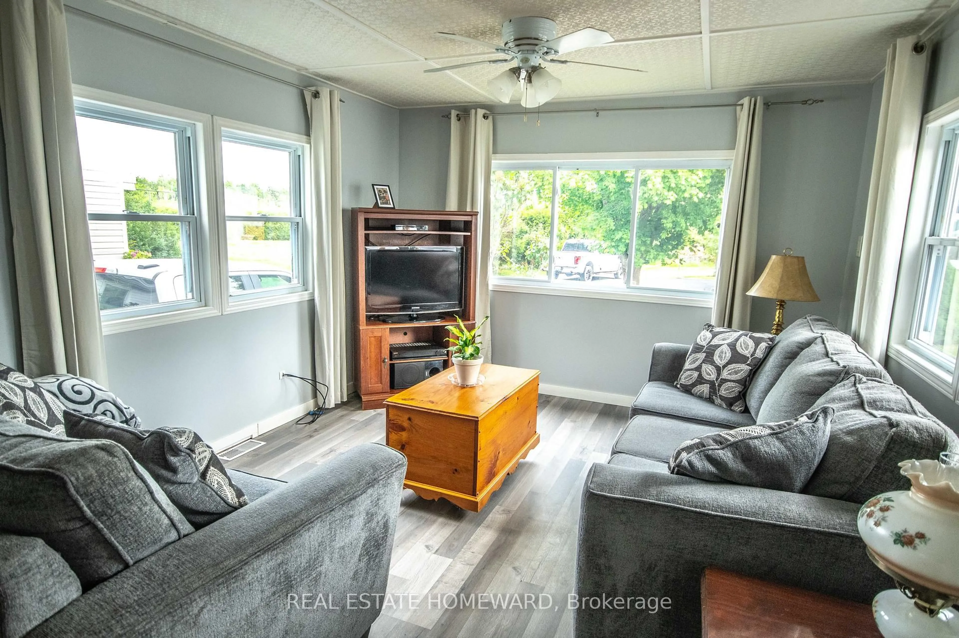 Living room with furniture, wood/laminate floor for 2244 Heritage Line #36B, Otonabee-South Monaghan Ontario K9J 6X8