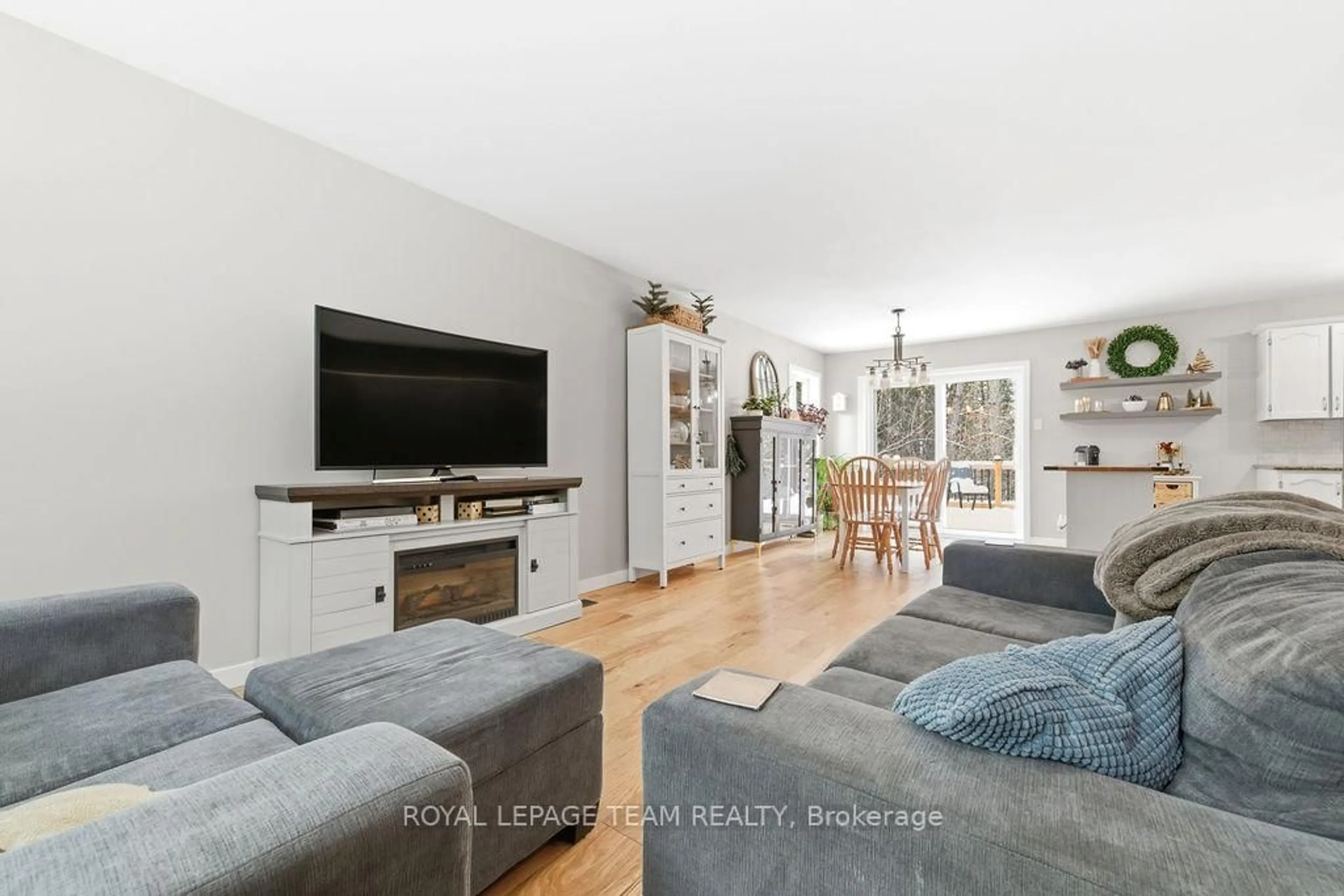 Living room with furniture, wood/laminate floor for 74 Castleford Rd, Renfrew Ontario K7V 3Z8