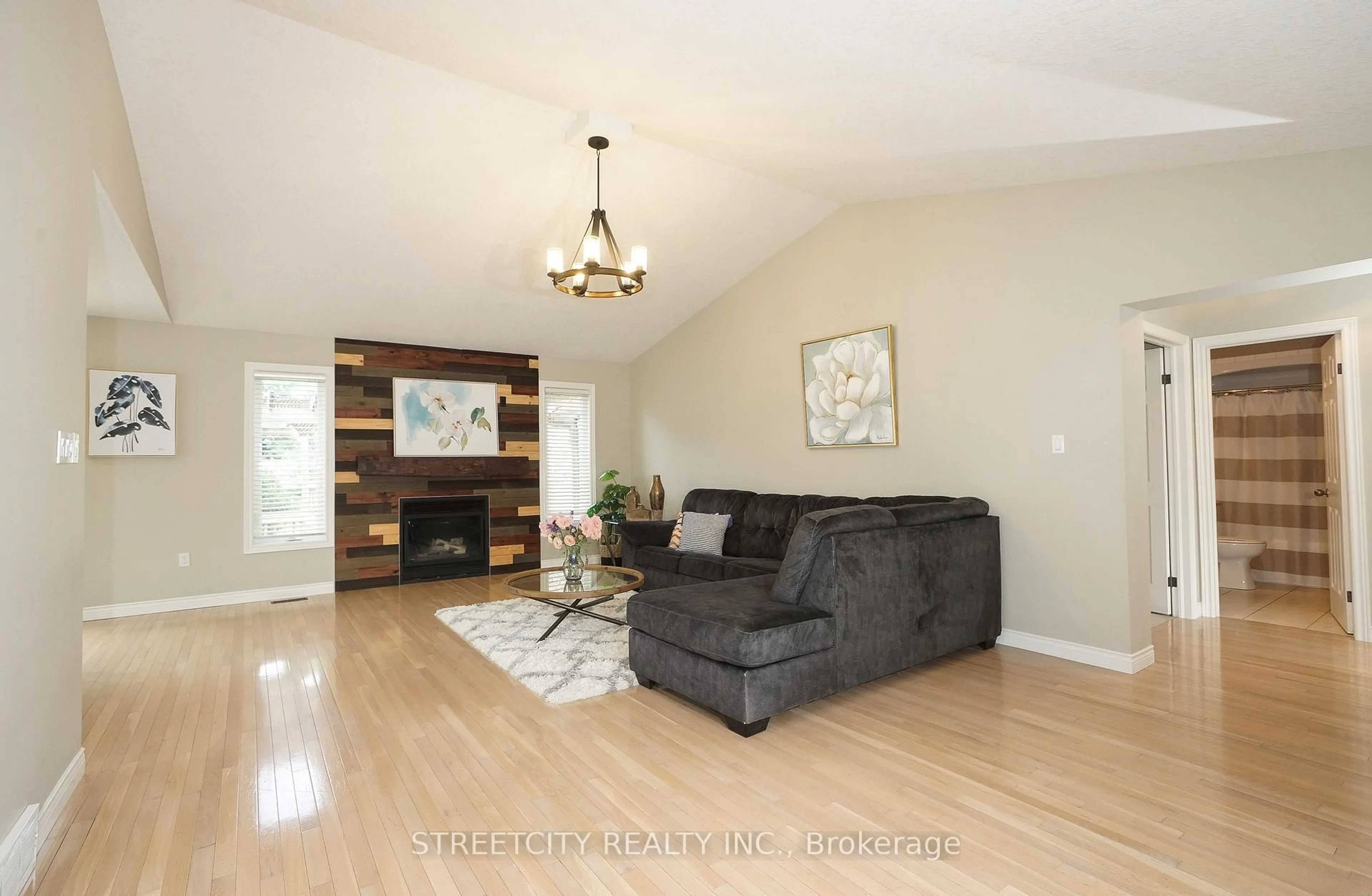 Living room with furniture, wood/laminate floor for 1861 Louise Blvd, London North Ontario N6G 5G2