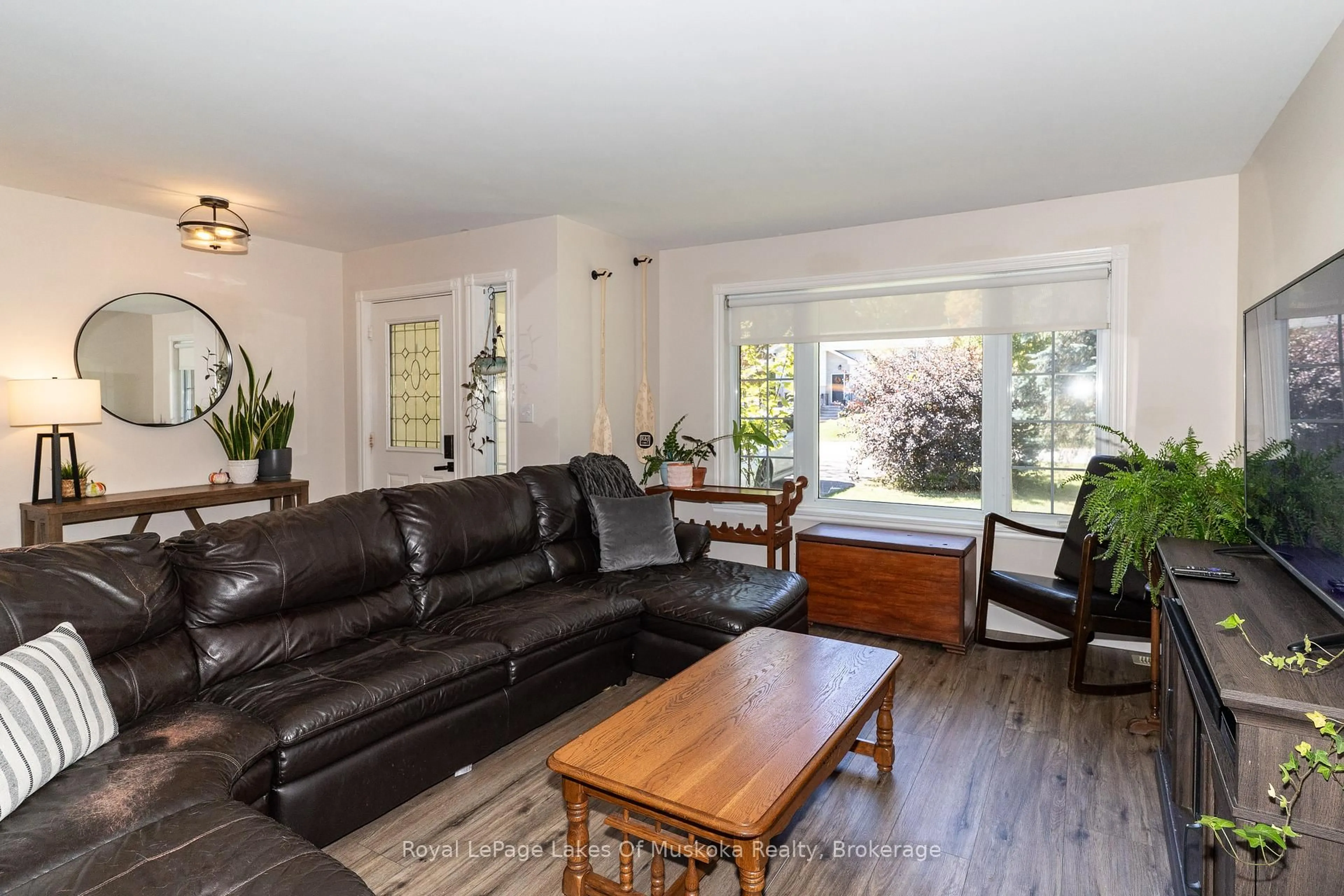 Living room with furniture, wood/laminate floor for 22 Knotty Pine Tr, Huntsville Ontario P1H 1S7