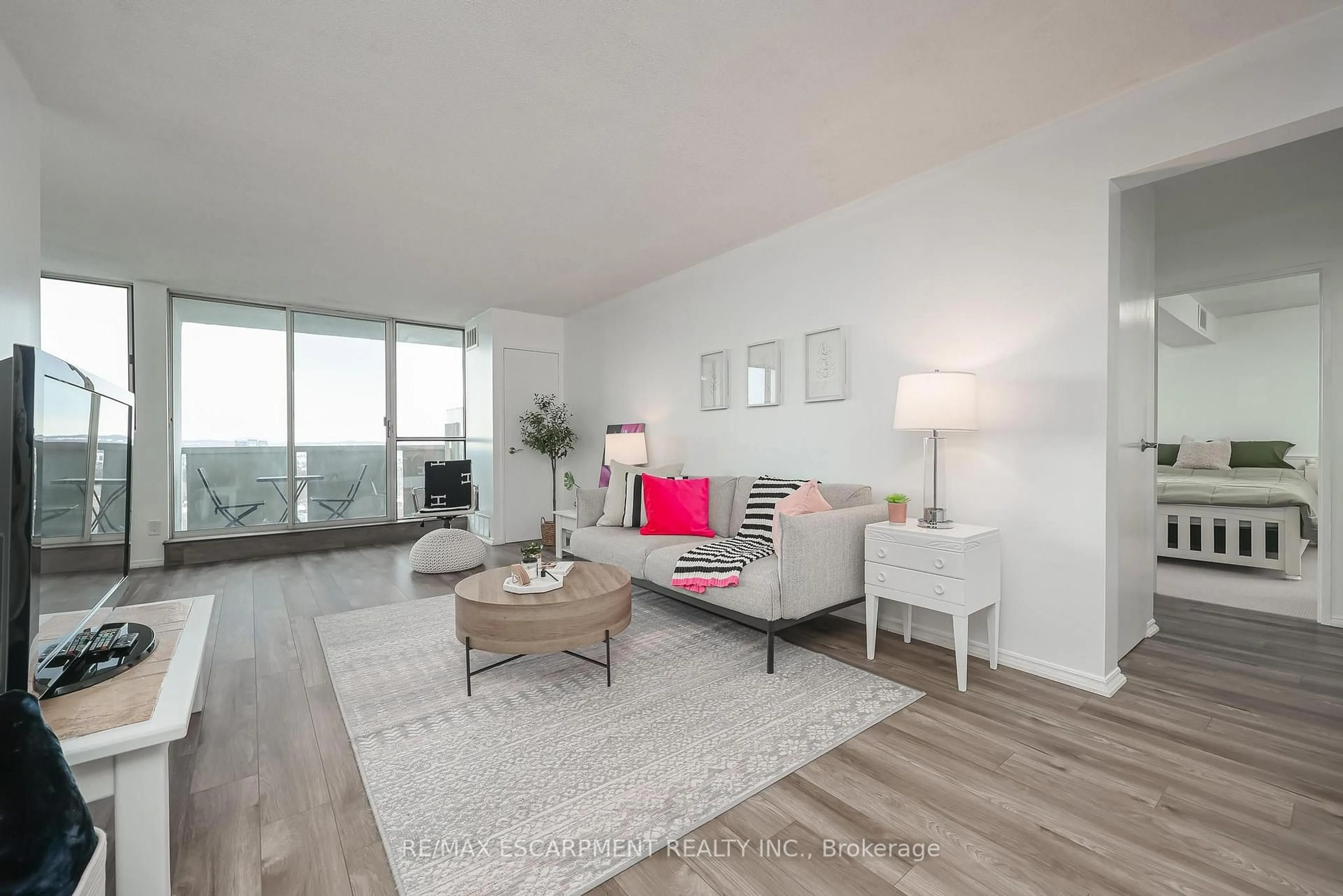 Living room with furniture, wood/laminate floor for 375 King St #1706, Kitchener Ontario N2J 4L6