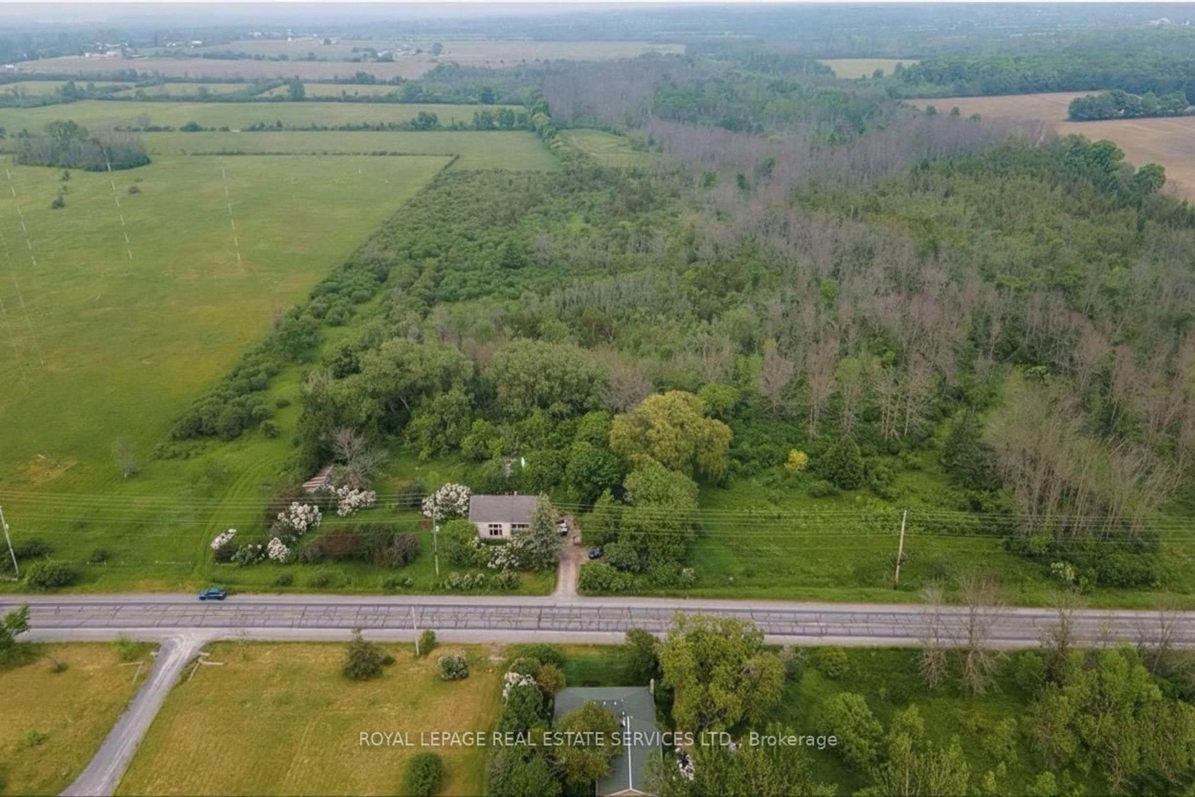 A pic from outside/outdoor area/front of a property/back of a property/a pic from drone, forest/trees view for 21062 Loyalist Pkwy, Prince Edward County Ontario K0K 1L0