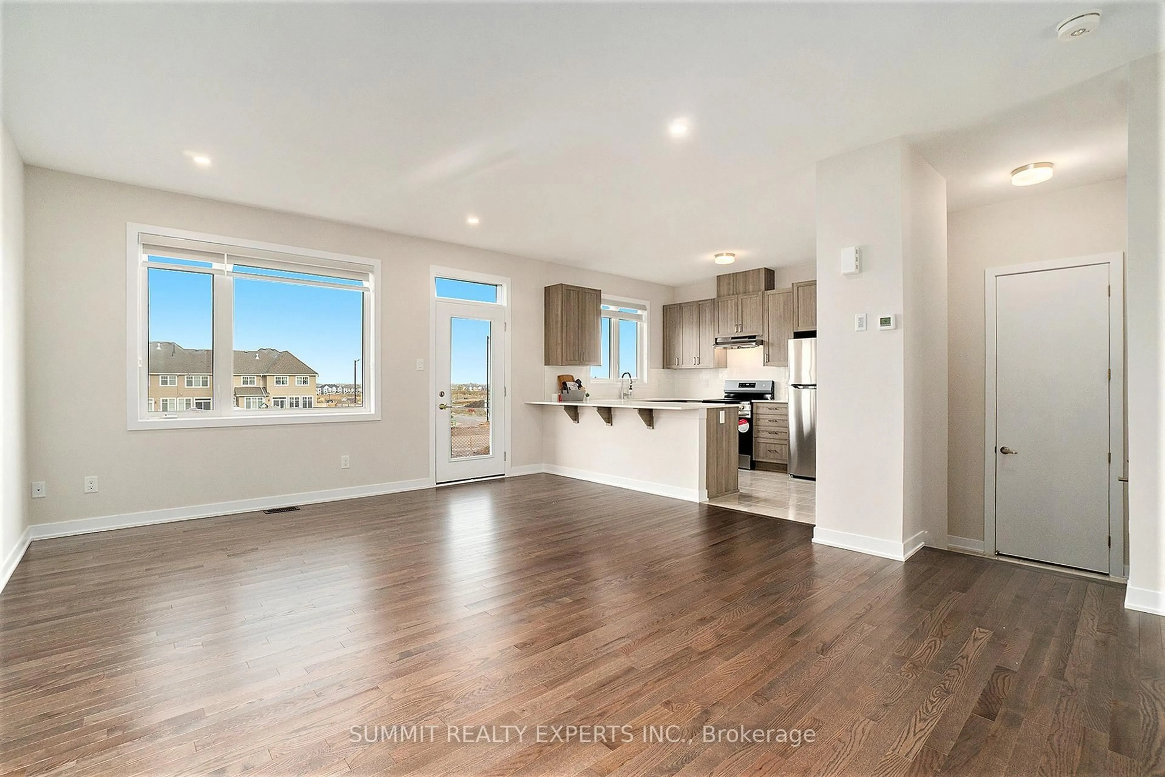 Open concept kitchen, wood/laminate floor for 104 BEEBALM Cres, Ottawa Ontario K2J 7G5