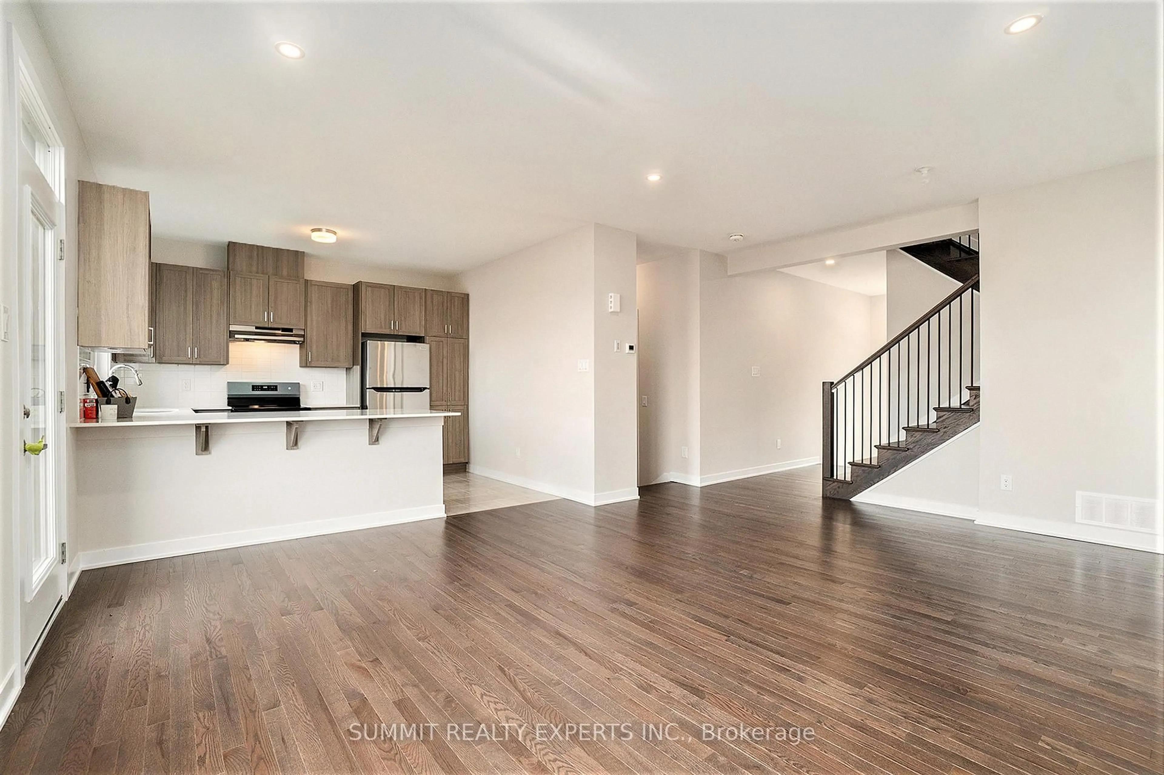 Open concept kitchen, wood/laminate floor for 104 BEEBALM Cres, Ottawa Ontario K2J 7G5