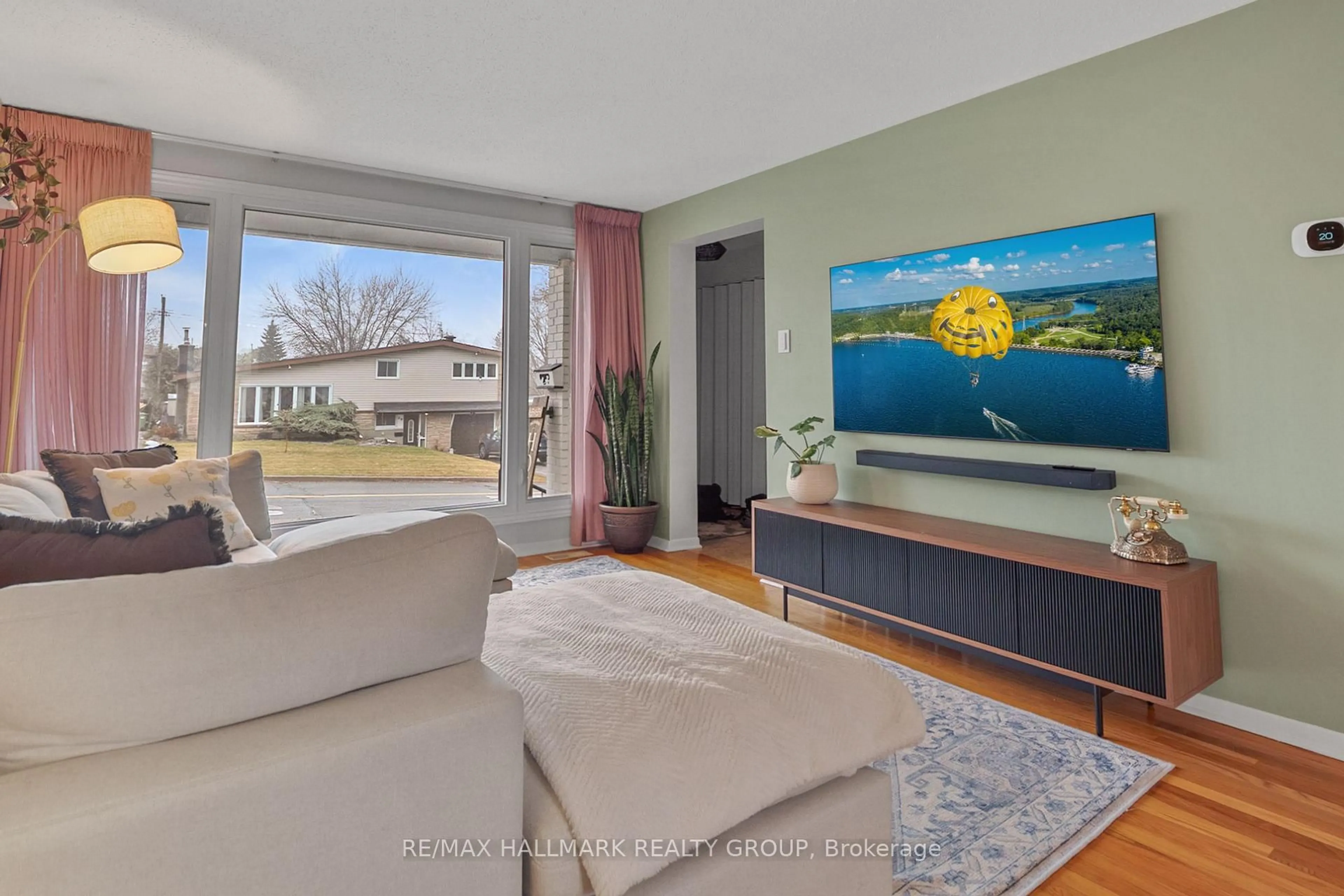 Living room with furniture, wood/laminate floor for 30 Tiverton Dr, Ottawa Ontario K2E 6L7