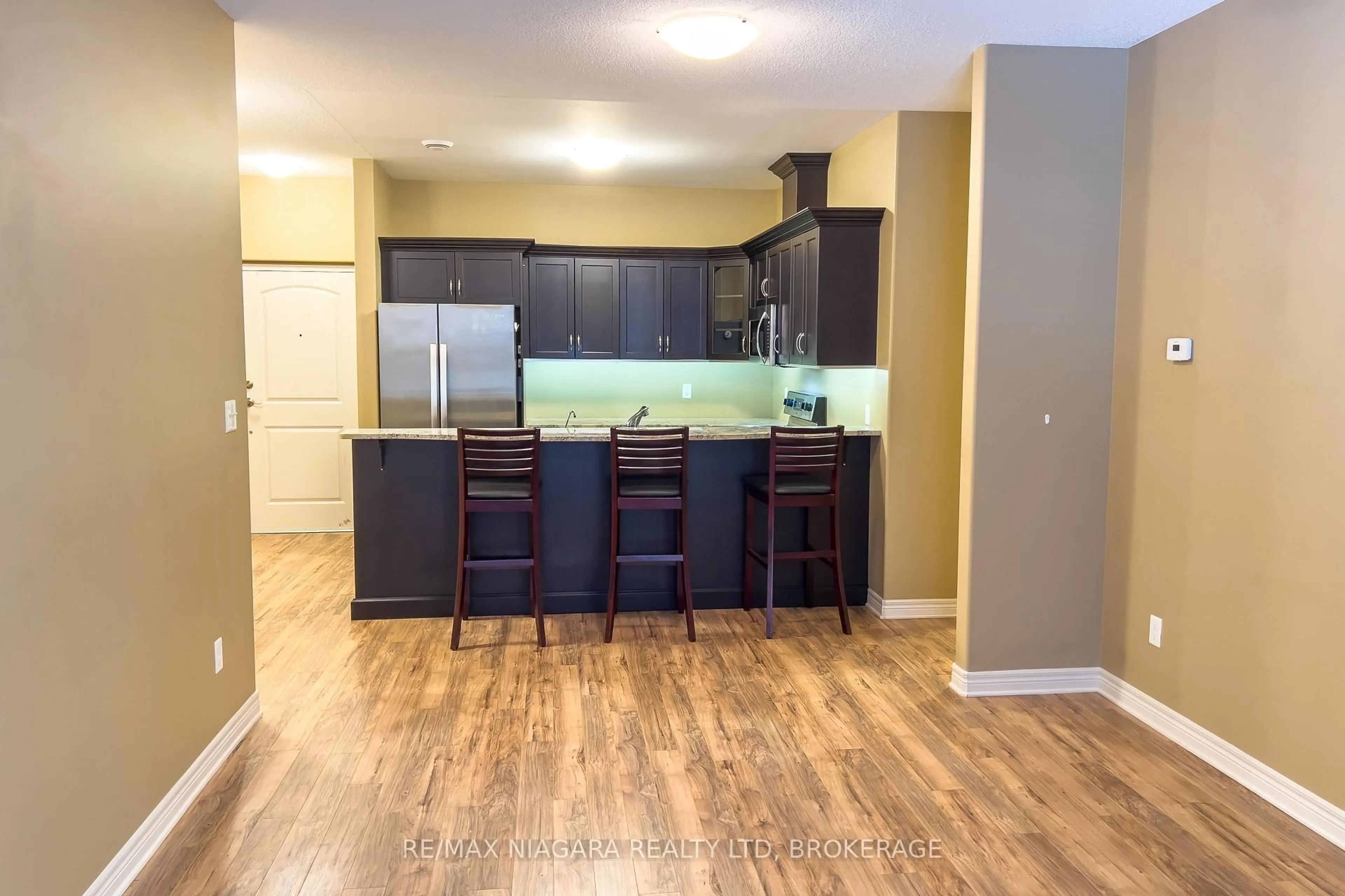 Open concept kitchen, wood/laminate floor for 2799 St. Paul Ave #306, Niagara Falls Ontario L2J 2L3