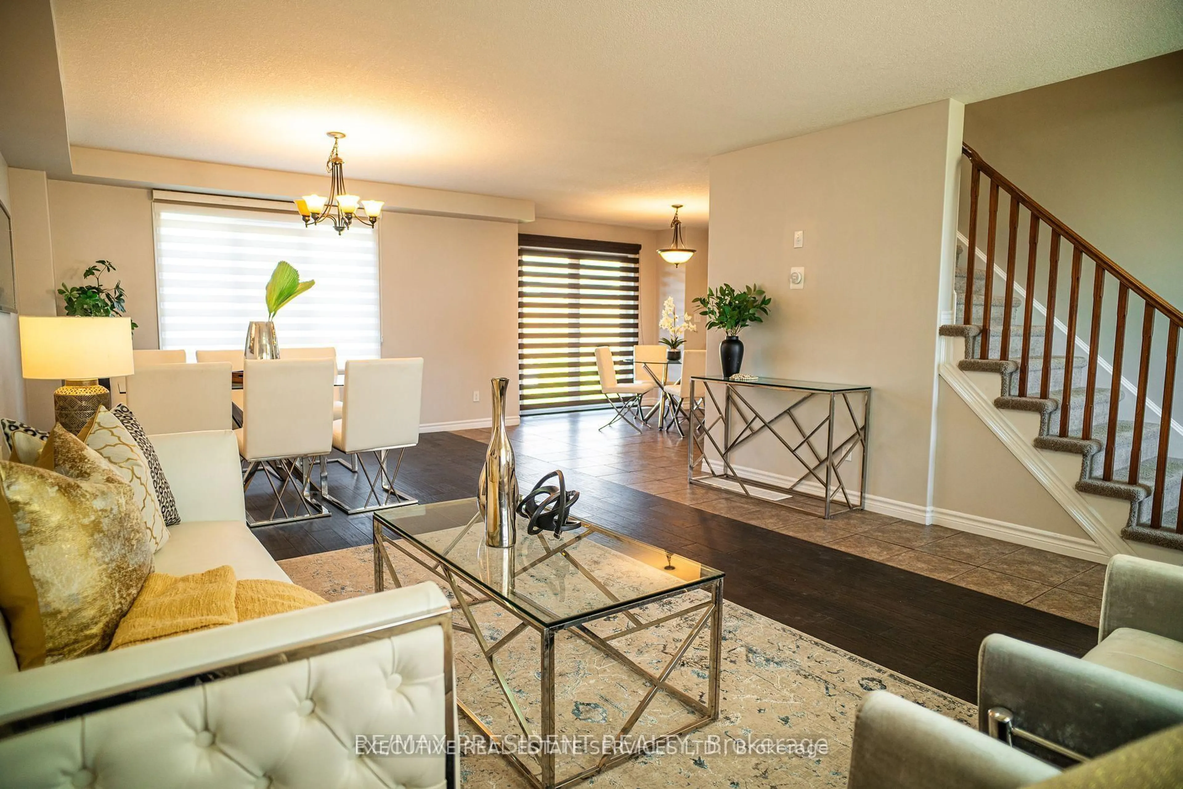 Living room with furniture, wood/laminate floor for 700 Spitfire St, Woodstock Ontario N4T 0B1