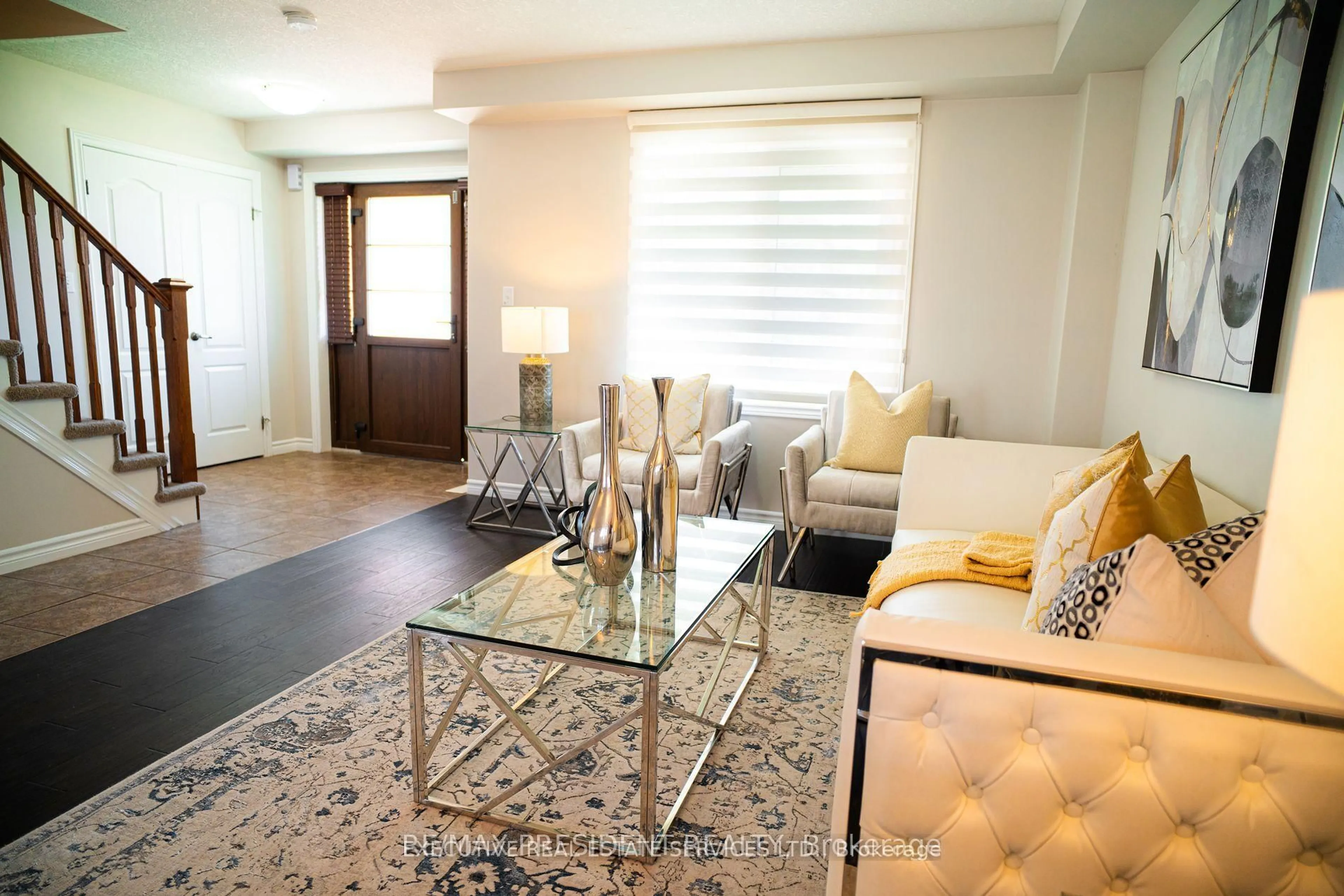 Living room with furniture, wood/laminate floor for 700 Spitfire St, Woodstock Ontario N4T 0B1