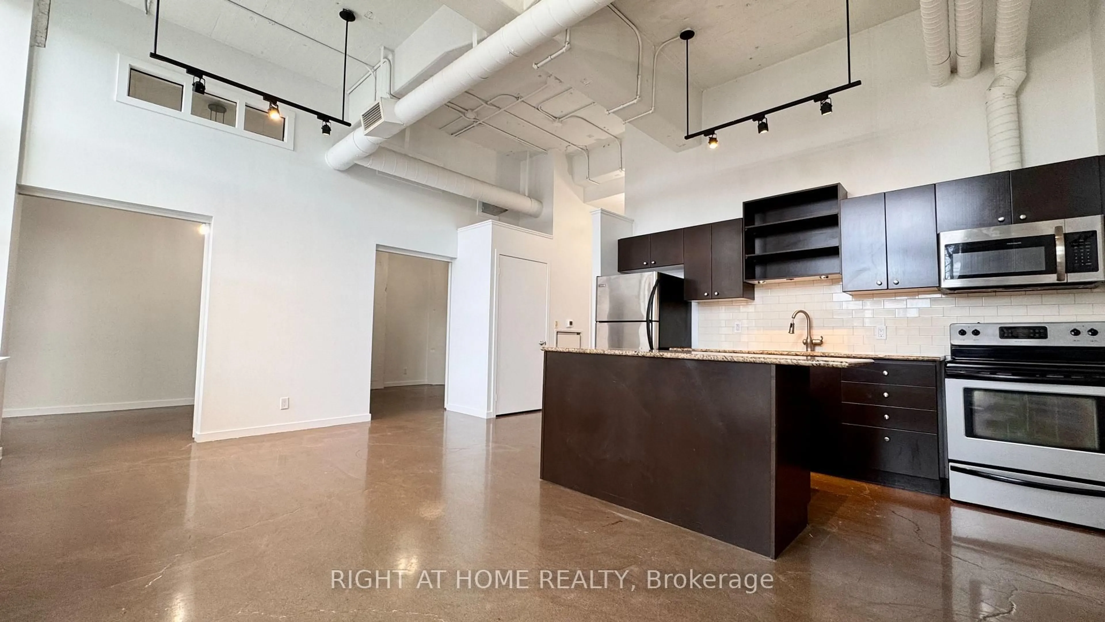 Open concept kitchen, cement floor for 410 King St #101, Kitchener Ontario N2G 1C3